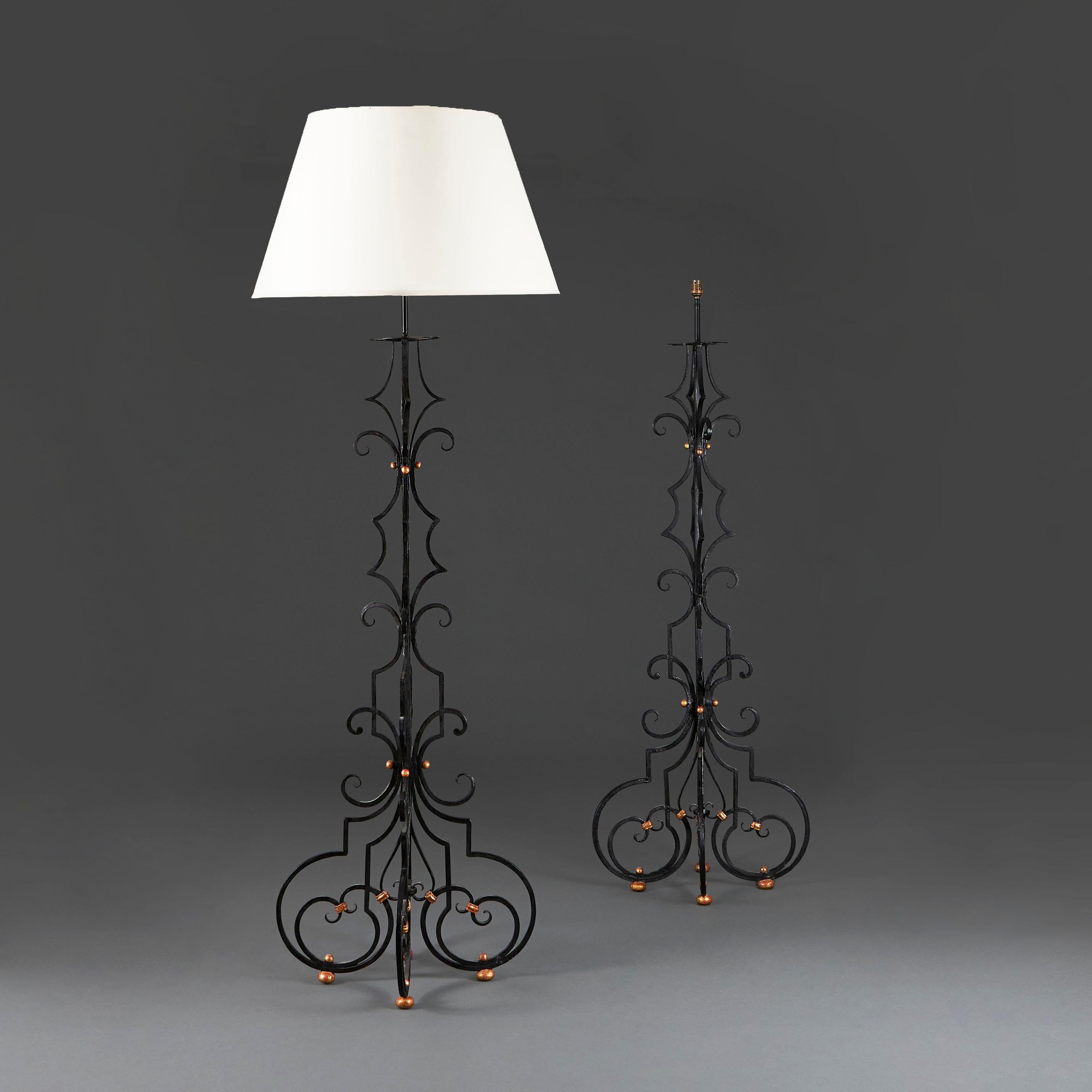 Spain, circa 1890

A pair of late nineteenth century wrought iron ebonised standard lamps, with flared bottoms, gilded balls and foliate metalwork.

Height 147.00cm
Height with lampshade  185.00cm
Width of base  53.00cm