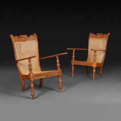 A Pair of Sri Lankan Teak and Cane Planters Chairs