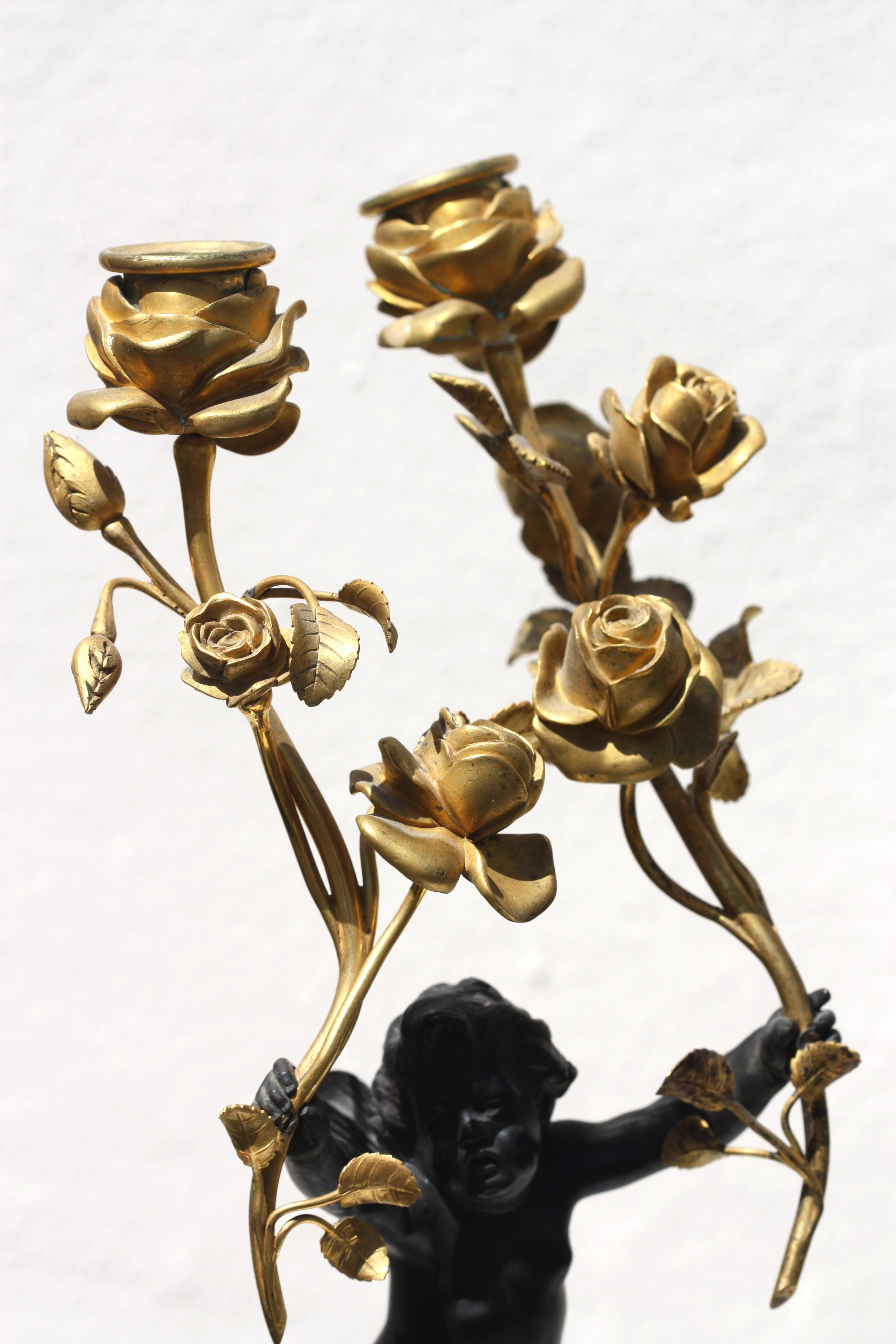 20th Century Pair of Standing Cherub Patinated Bronze and Gilt-Bronze Figural Candelabrum For Sale