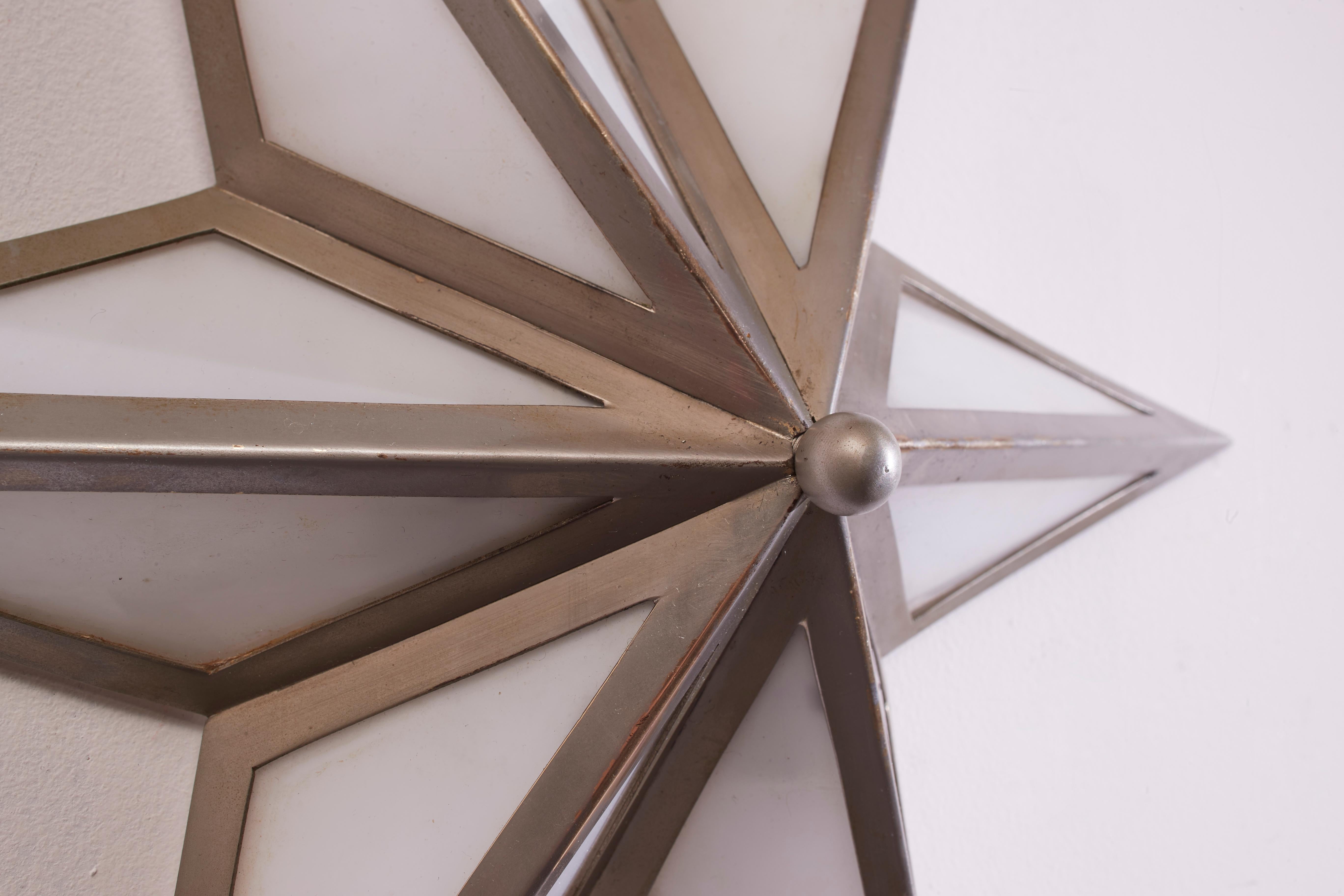 A pair of star-shaped wall sconces made of steel and glass, Italy, 1960s 3