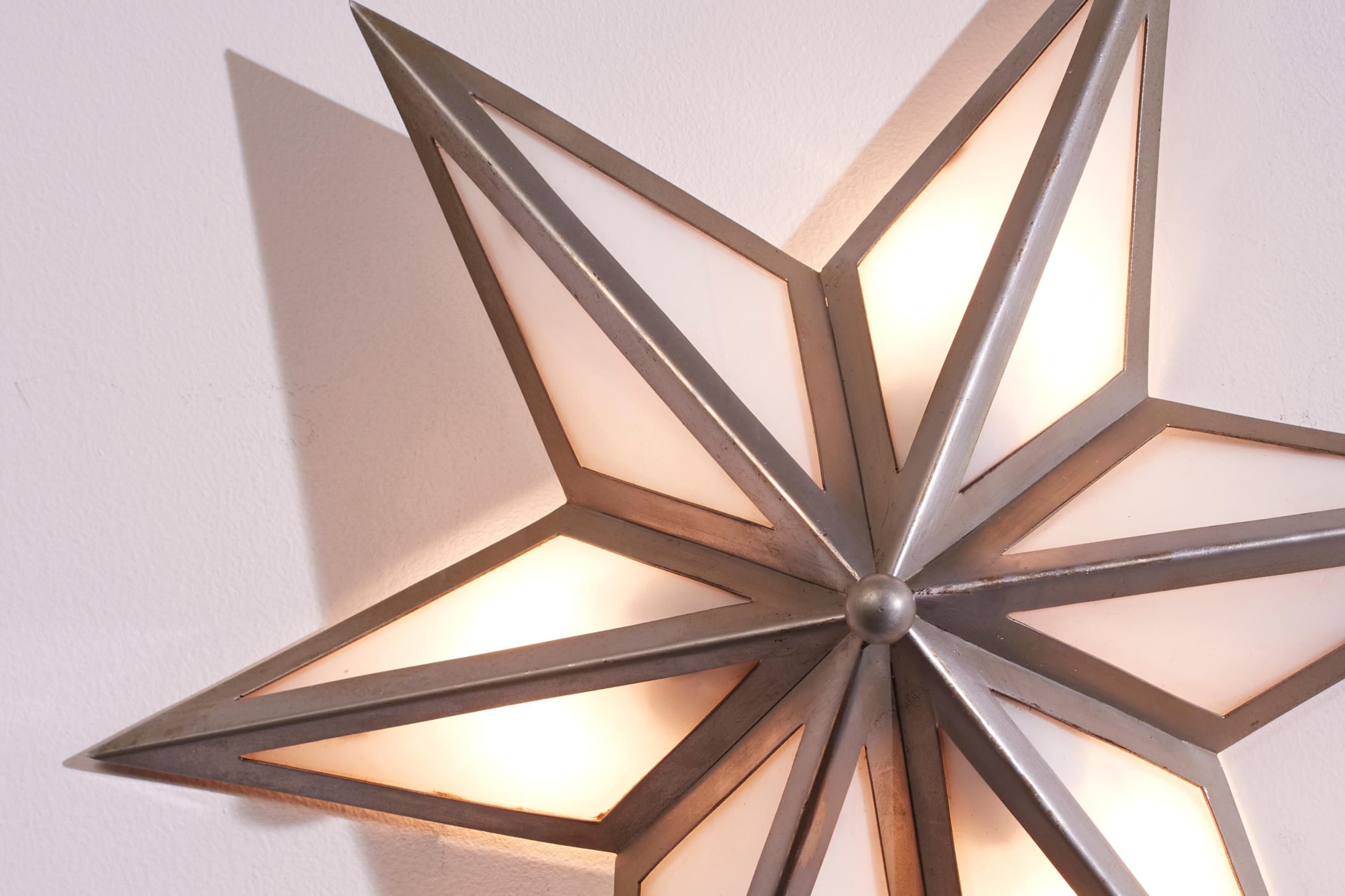 Steel A pair of star-shaped wall sconces made of steel and glass, Italy, 1960s