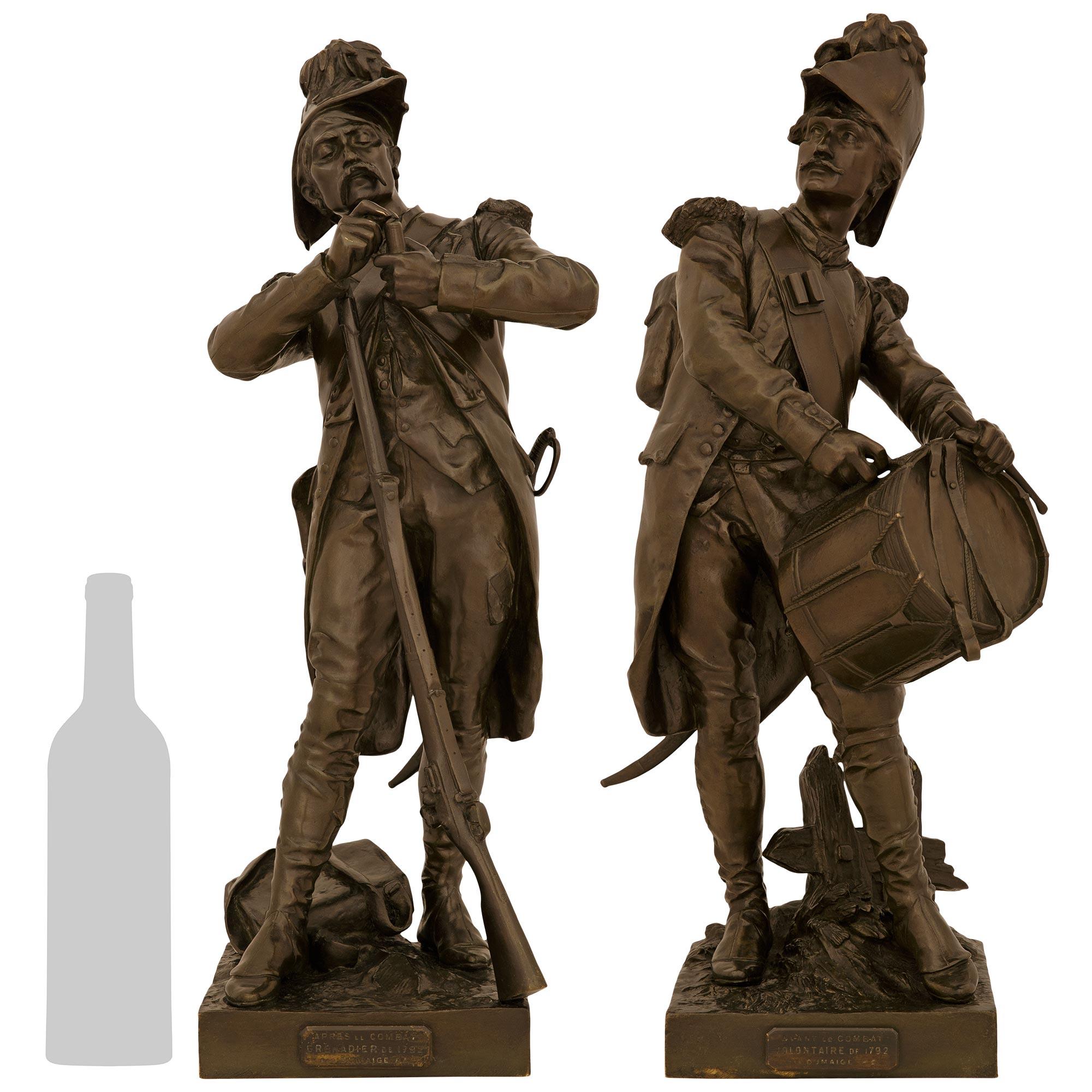 A handsome and large scale pair of French 19th century patinated Bronze statues named Avant Le Combat and Apres Le Combat, signed by Dumaige. This wonderful pair are raised by square bases mounted with front plaques inscribed with the name of each