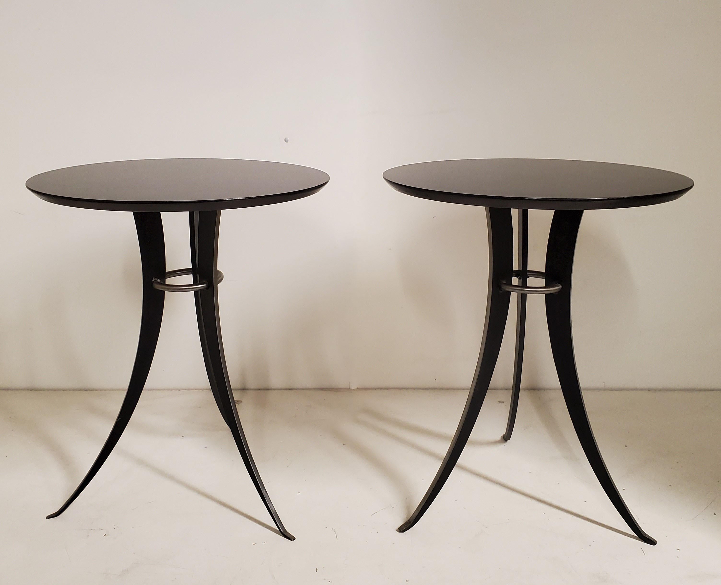 A Minimalist pair of tulip design, splay leg end tables in steel and lacquered wood. 
The austere and streamline design make this pair appealing in any decor.
These can be used as side or drinks tables in any room setting Ex: Art Deco, Hollywood