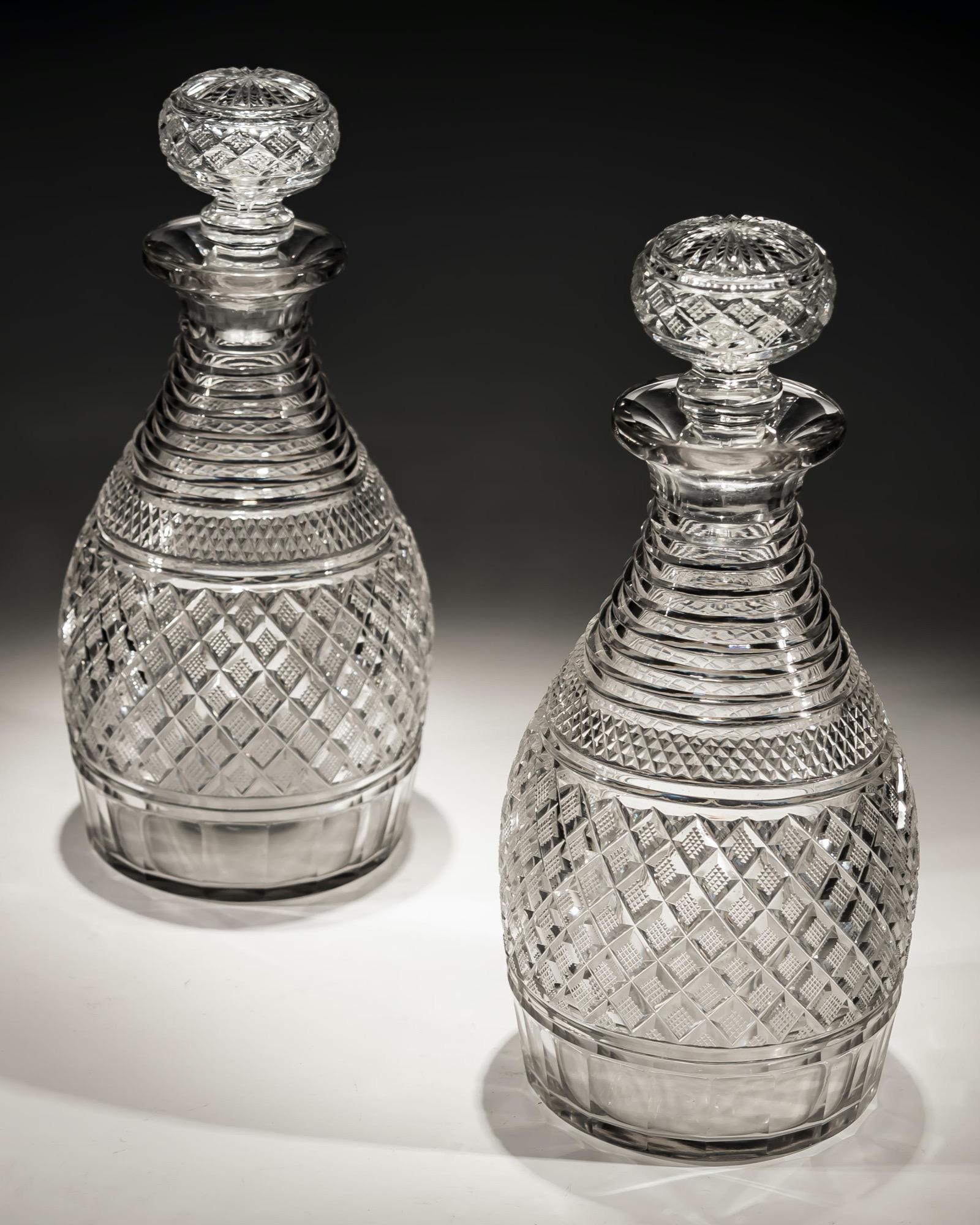 A pair of step and strawberry diamond cut Regency decanters.
Measures: Height 26 cm (10 1/4