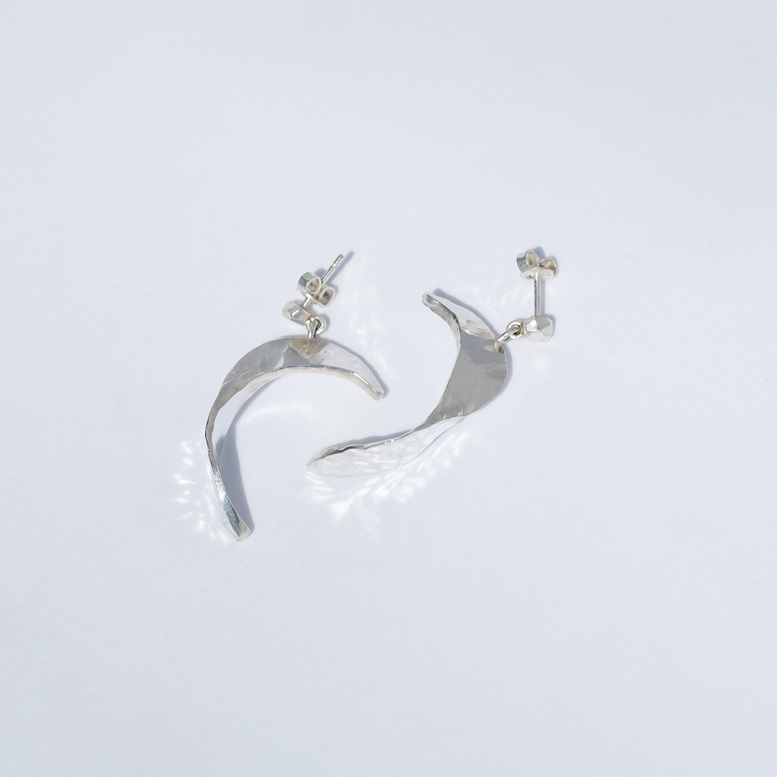 These sterling silver earrings are moon-shaped and they literally shine. The surface is hammered giving the earrings a handmade and genuine look.

The earrings work well for both special events and an everyday use. 

Have you seen the matching