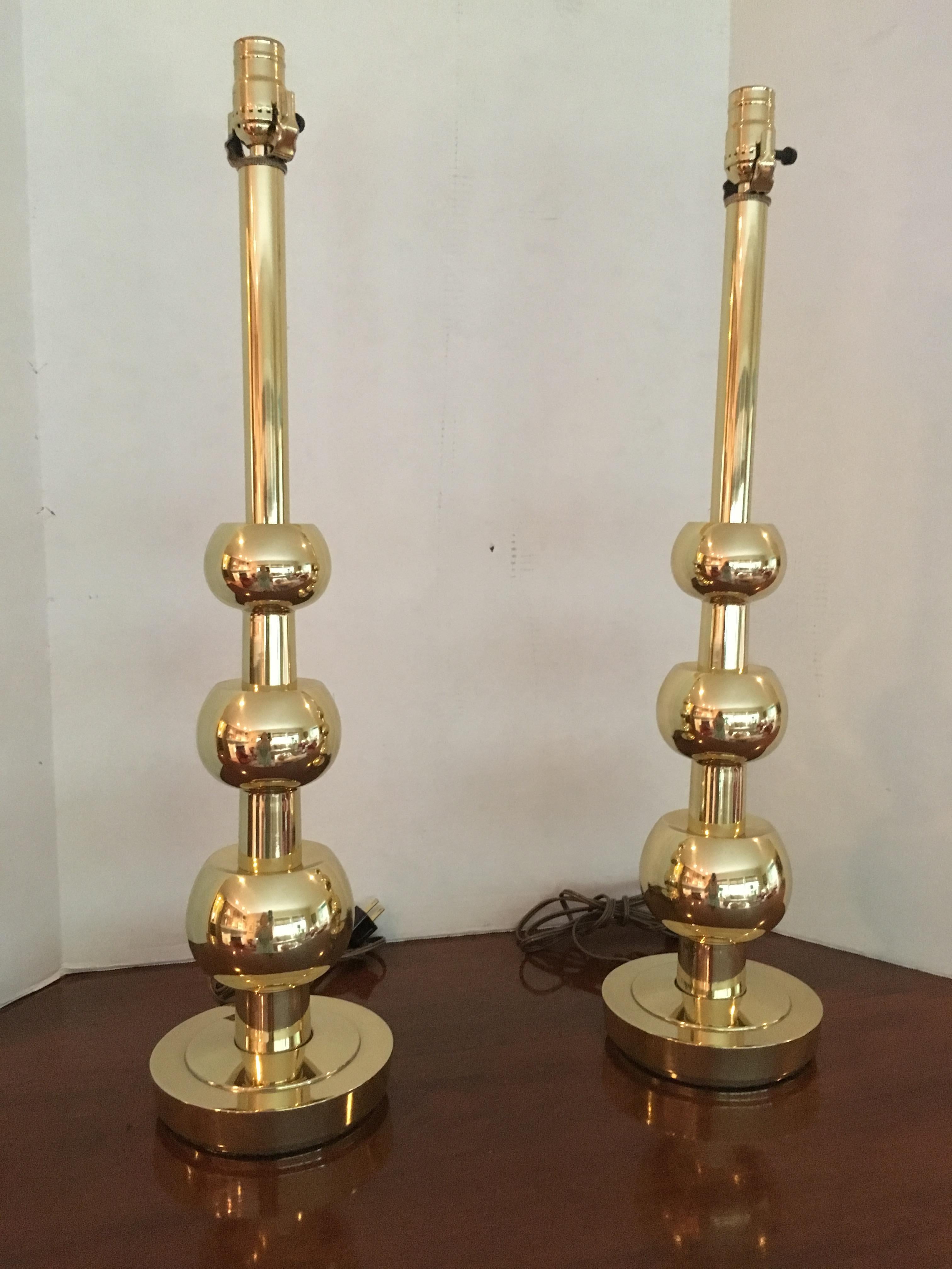 A pair of 3 ball brass table lamps. Recently re-brassed.