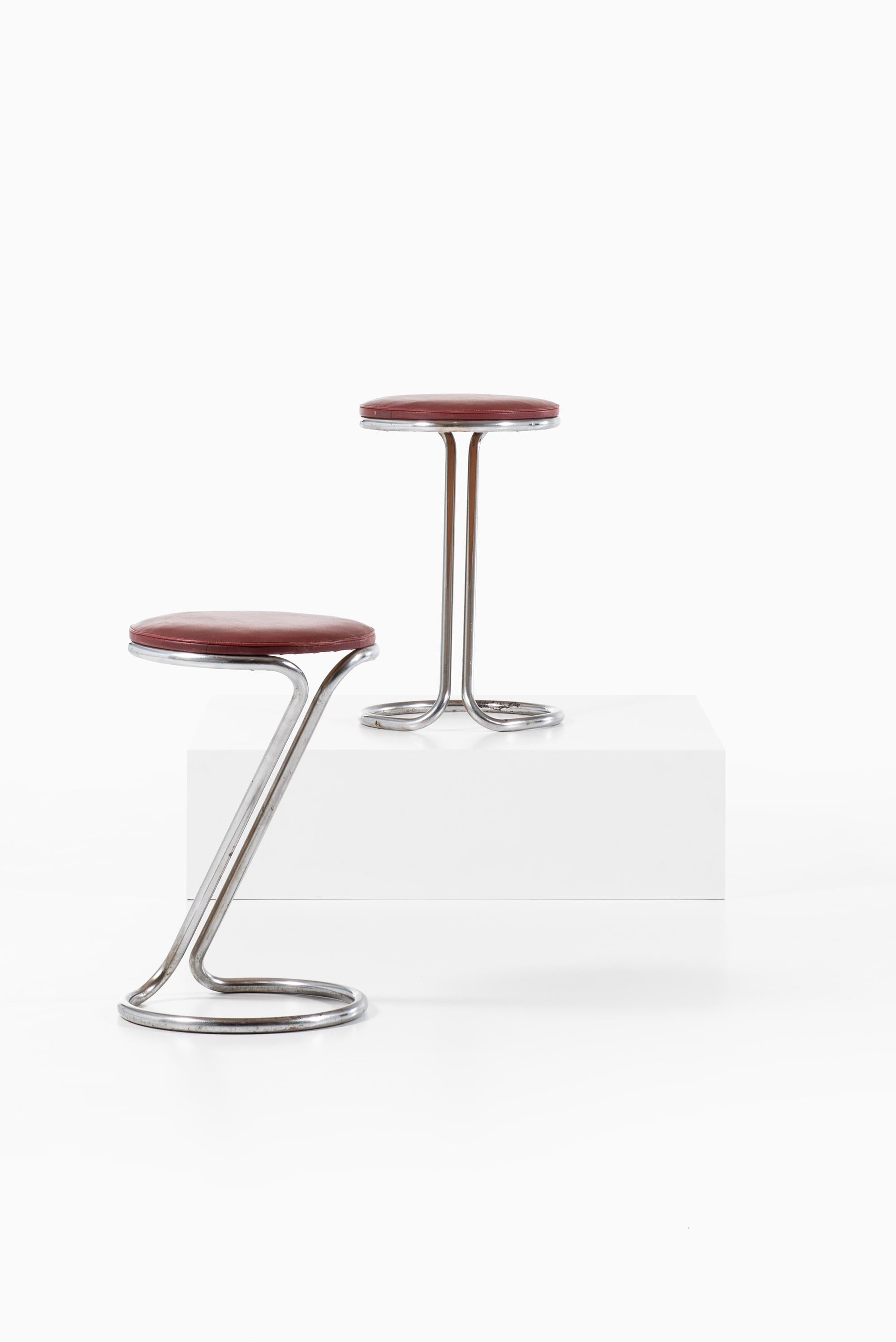 A pair of stools in the manner of Poul Henningsen. Produced in Denmark.