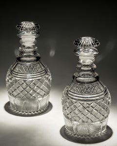 A pair of strawberry diamond cut Georgian decanters