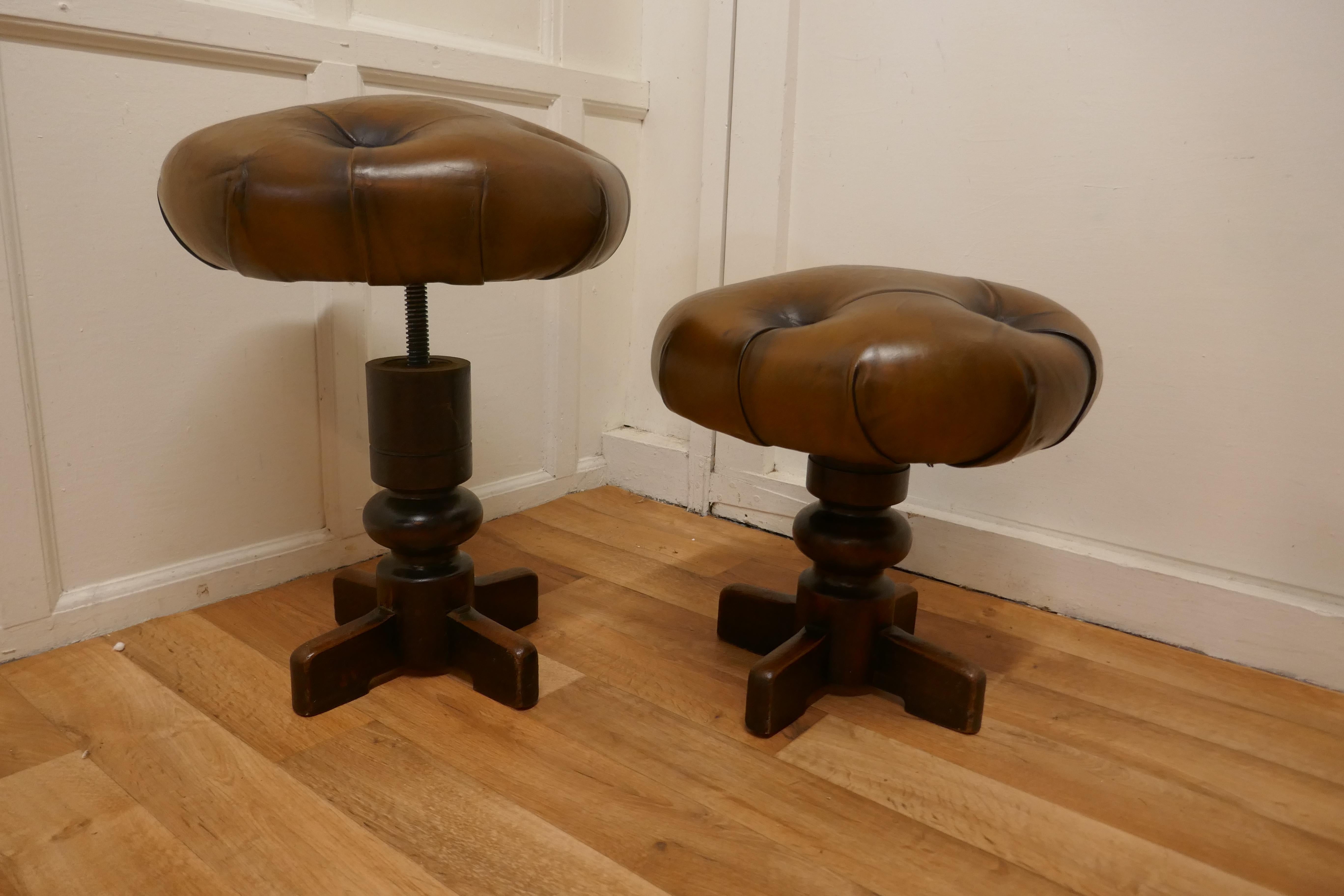 A Pair of Sturdy French button leather Swivel piano stools 


These are sturdy heavy quality pieces, the stools have a heavy baluster column with a 4 footed base, the tops are deeply upholstered with good quality hide, this is old but in good