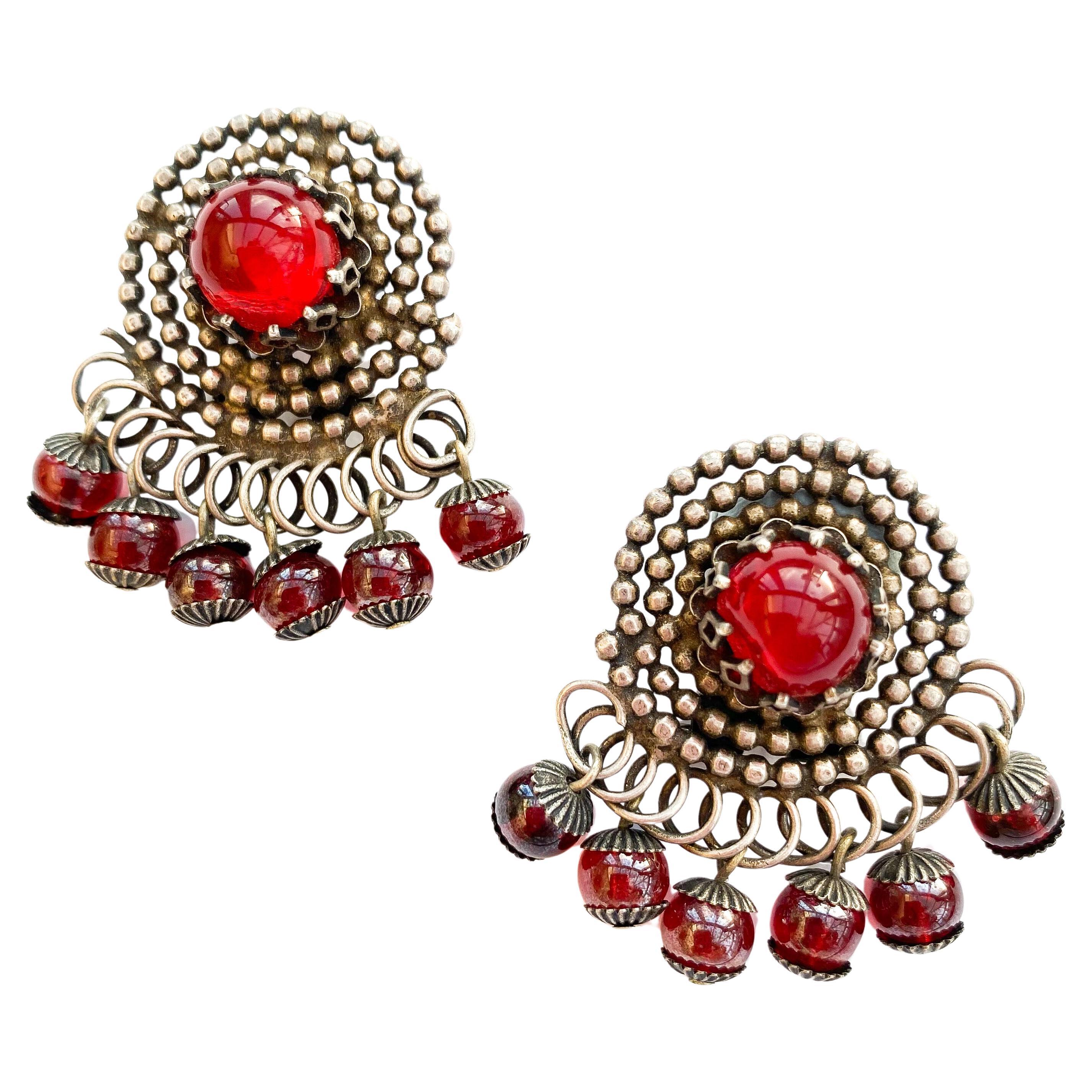 A pair of stylised silvered metal and red glass 'swirl' earrings, France, 1950s For Sale