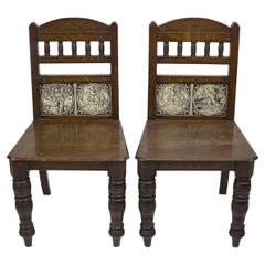 Antique A pair of substantial Gothic Revival oak hall chairs with period tiles