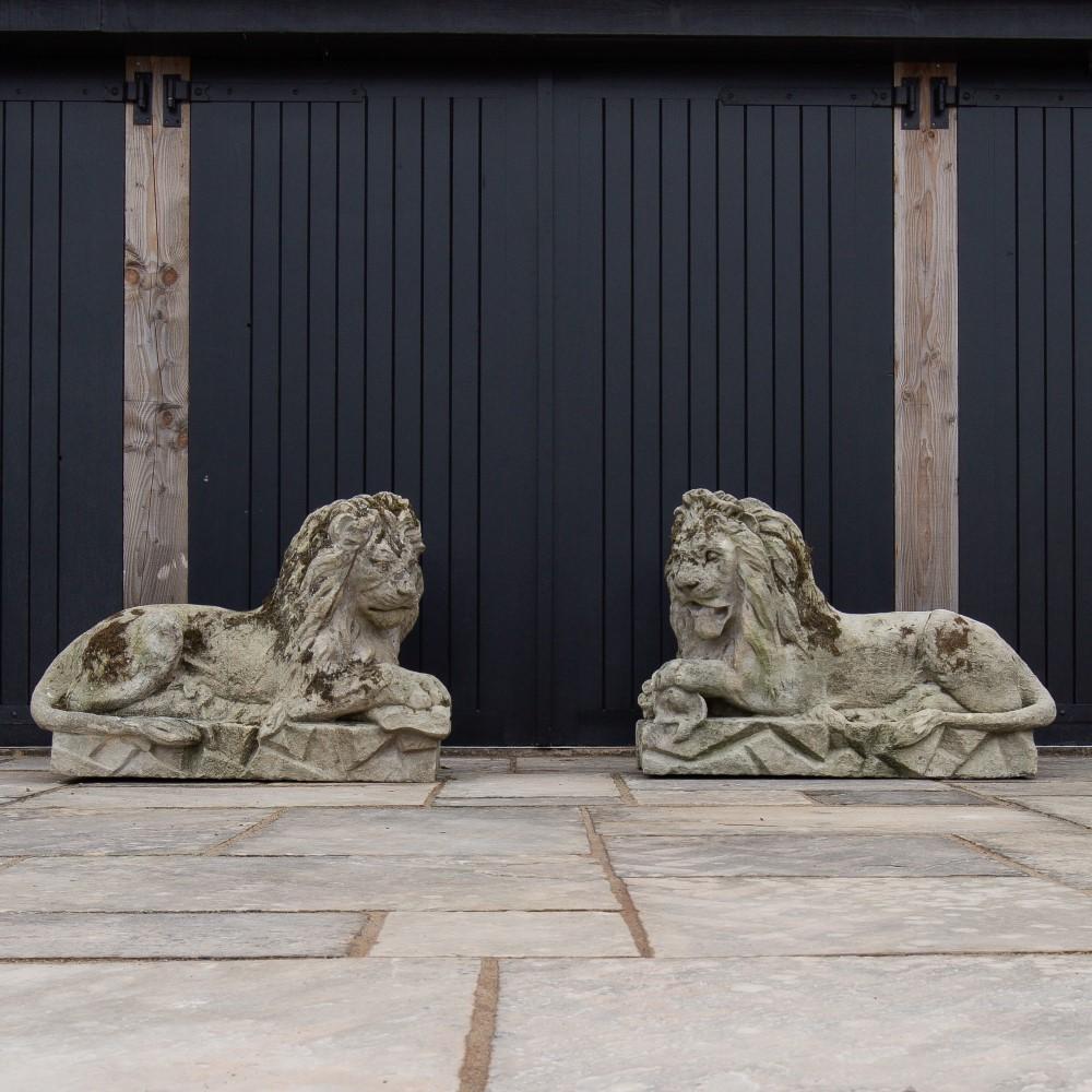 A pair of superb and rare 18th century Bath stone opposing recumbent lions with their paws resting on bones and with one lions mouth open.

Around 160 million years ago, the land that became Combe Down in Somerset, was under a warm, shallow,