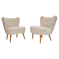A pair of Swedish coctail / lounge armchairs in sheepskin, ca. 1940