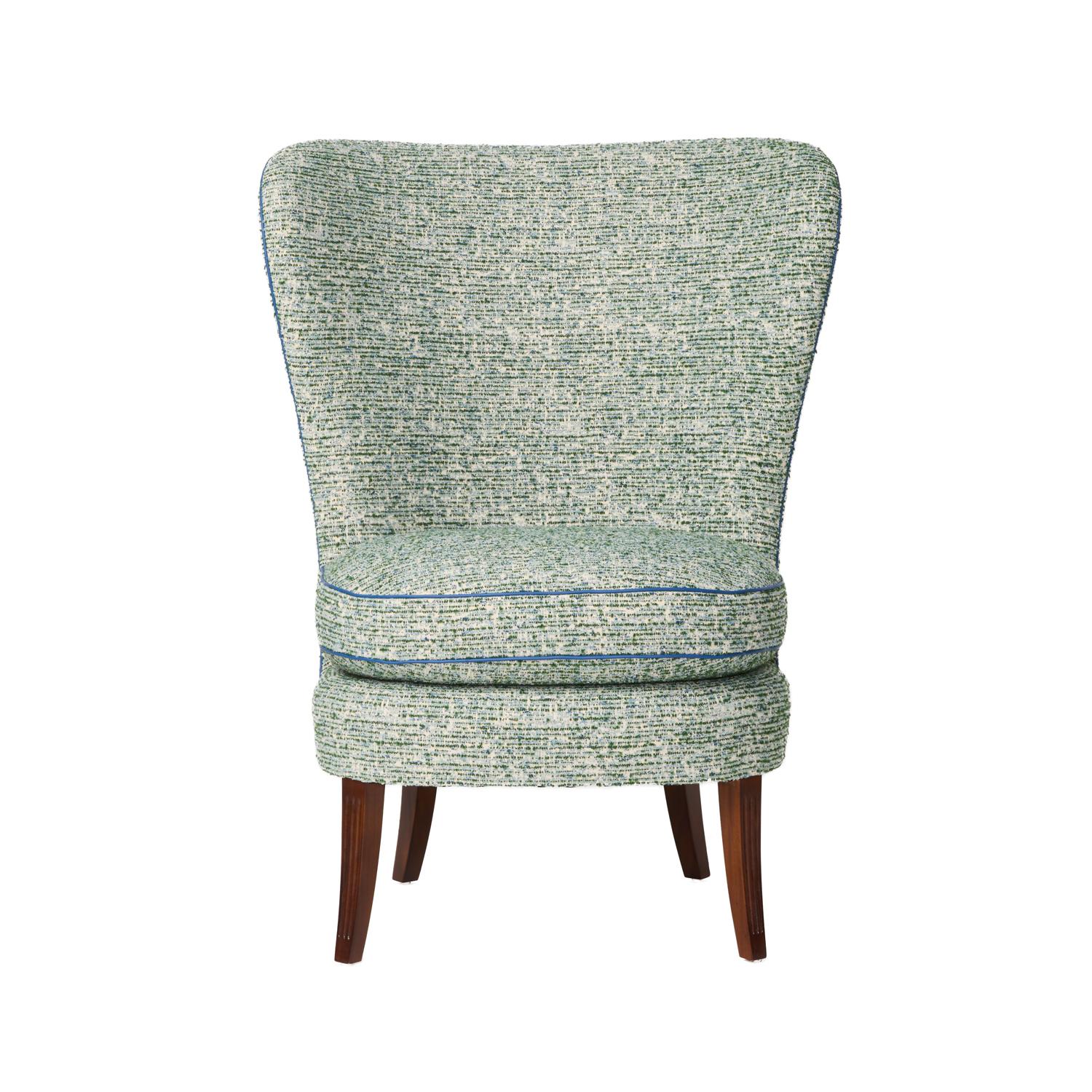A Swedish Grace period high back chair with curved sides, suggesting a wing chair. The walnut saber-form back legs splayed and the front legs square and tapered with fluting. Supporting fully upholstered deck with a loose seat cushion. Circa 1920.