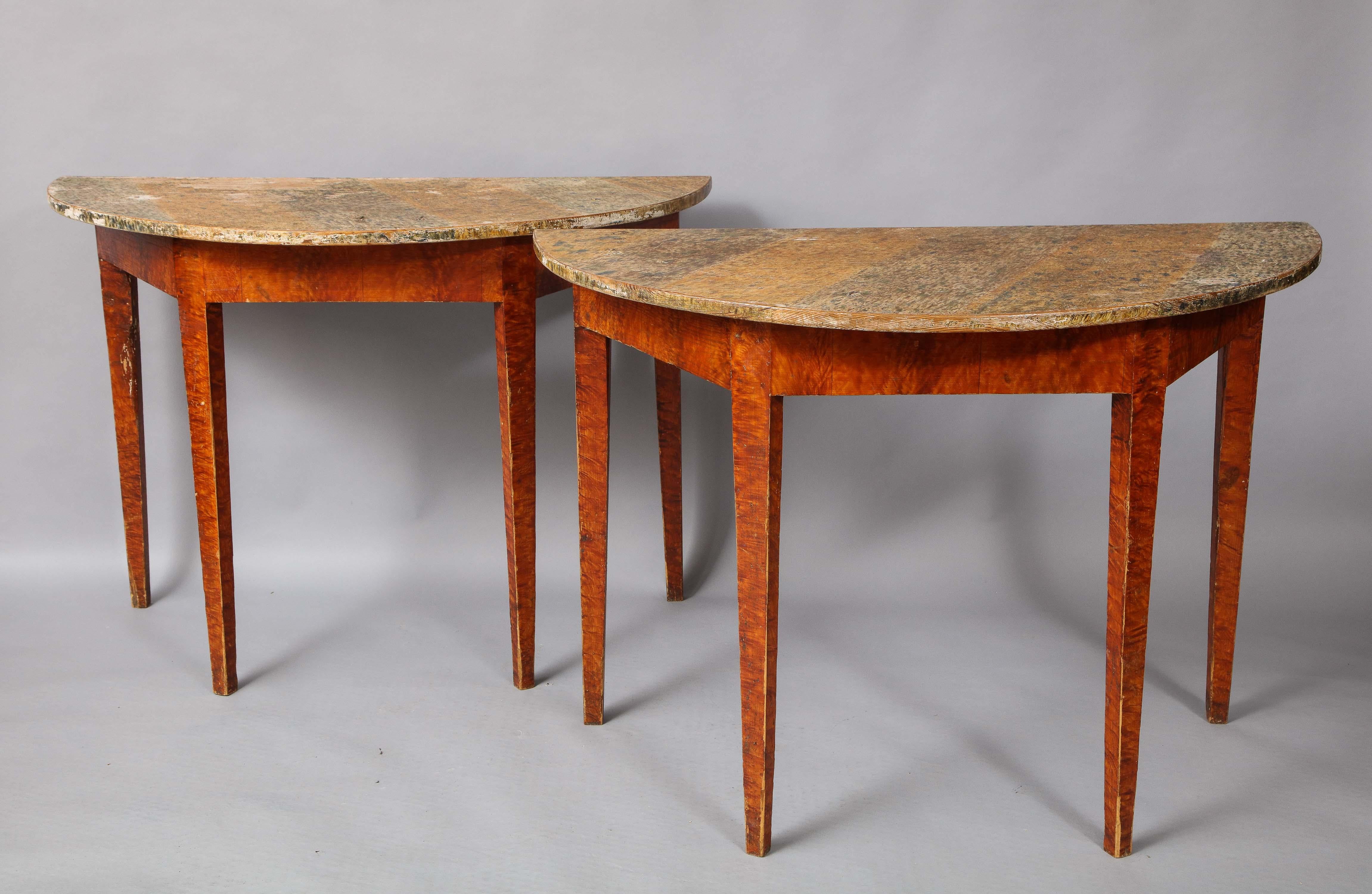 A pair of Swedish grain painted demilune side tables, the D-shaped tops painted in imitation of marble, the bases painted in imitation of flame birch.

Ex collection Bill Blass.



    