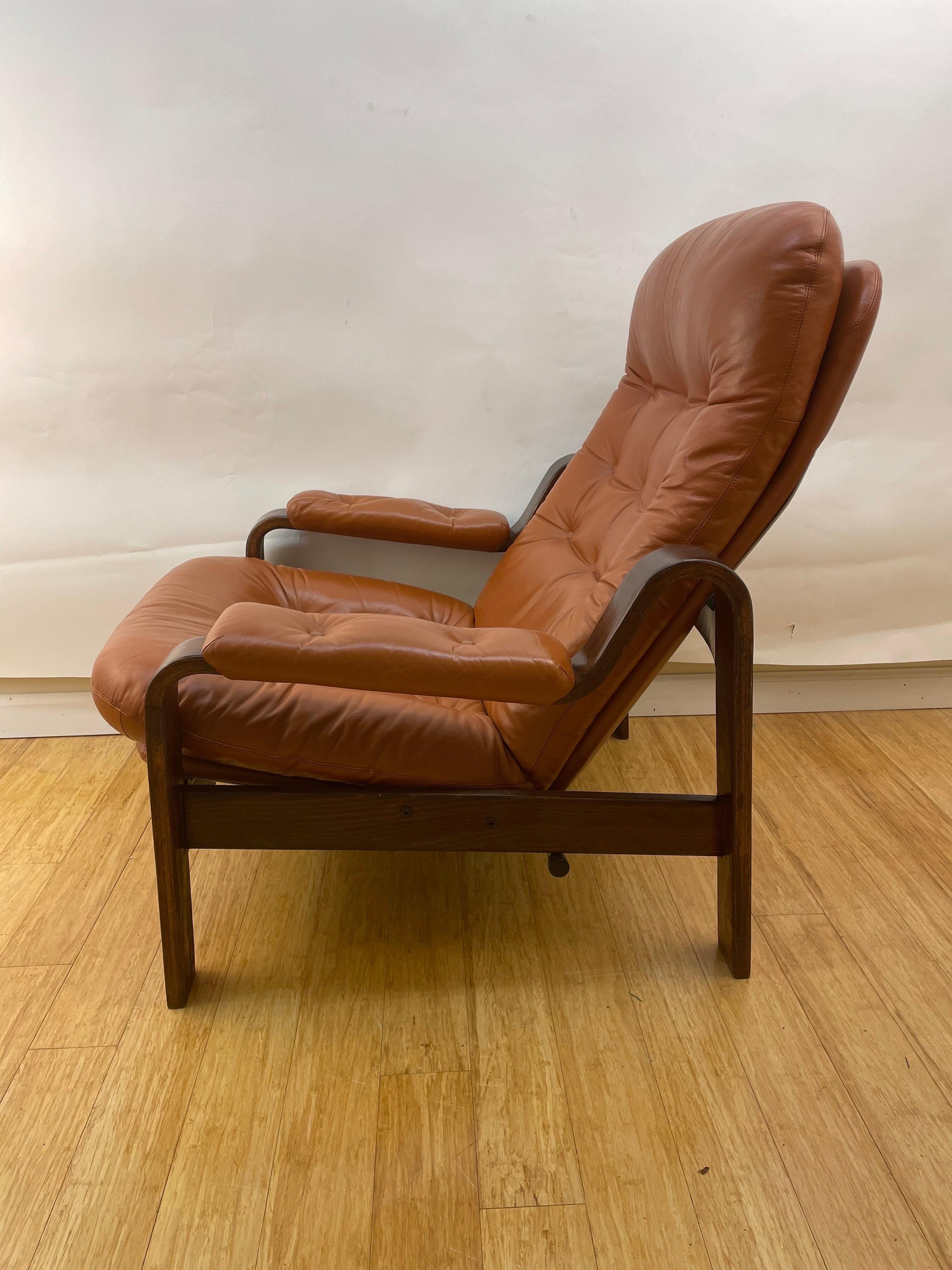 Sink back into these back-friendly leather armchairs, put up your feet and fall asleep watching your favorite Netflix! Th perfect reward after a stressful day. Crafted of walnut stained bent-wood and tufted caramel toned leather, these will become