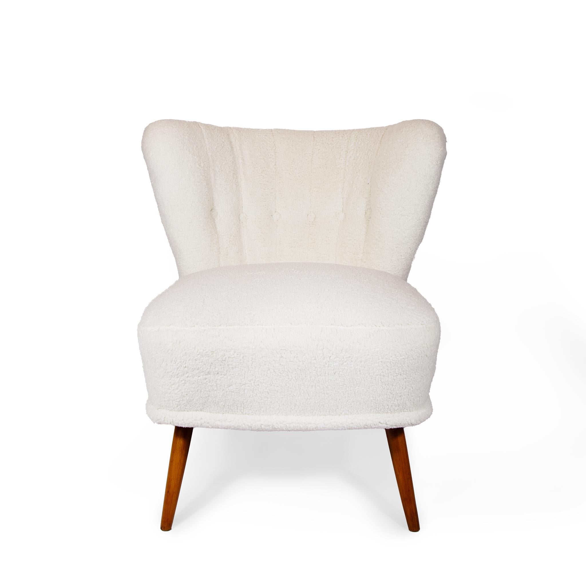 A pair of Swedish Modern Slipper Chairs, circa 1940s. They have stained birch legs and are newly upholstered in Maharam Puff Boucle fabric.