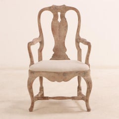 A pair of Swedish Rococo carved and whitewashed walnut armchairs, 18th C.
