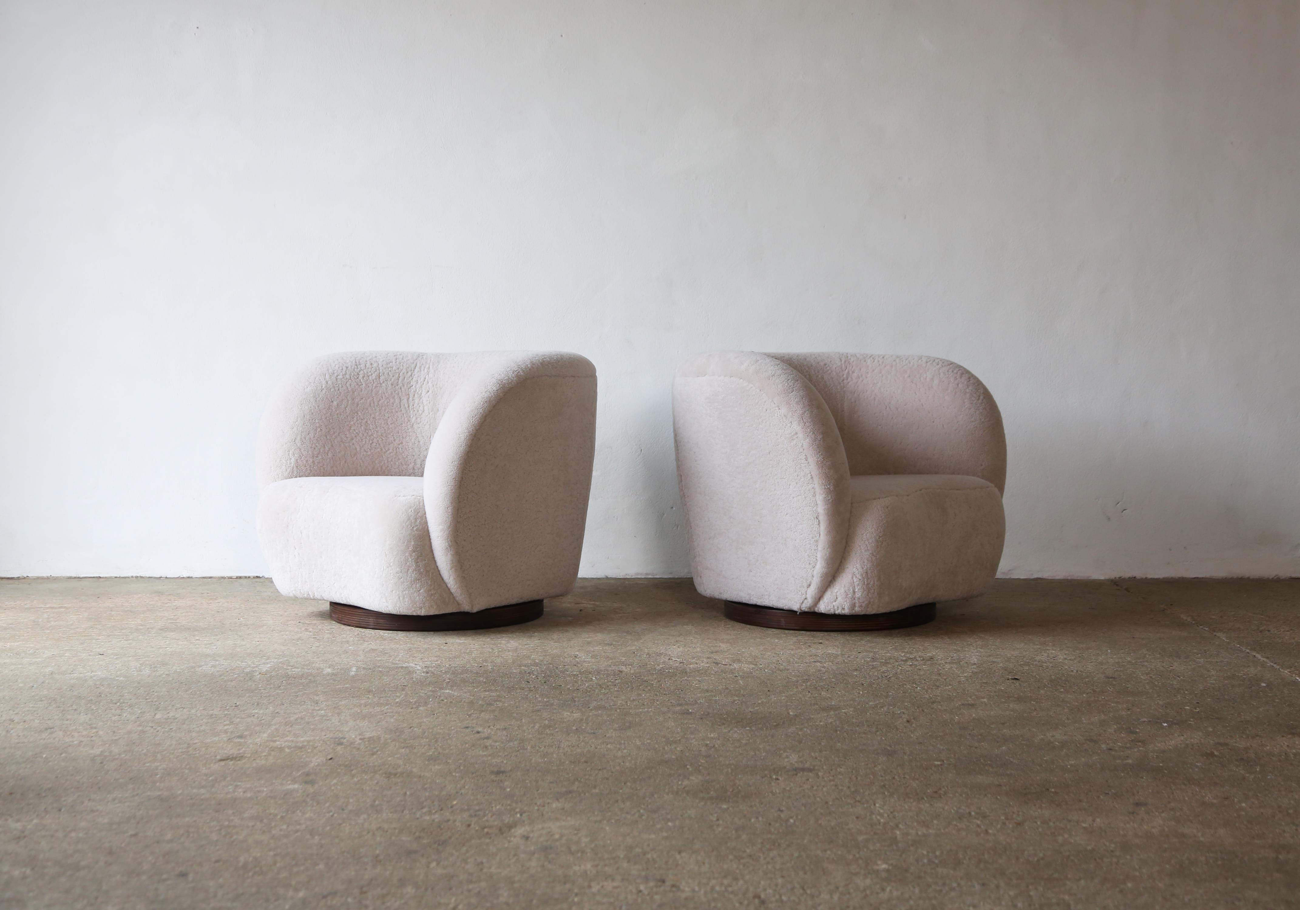 A pair of modern swivel chairs upholstered in natural sheepskin.  Handmade beech frames and sprung seats.  Available in COM.  Fast shipping worldwide.



