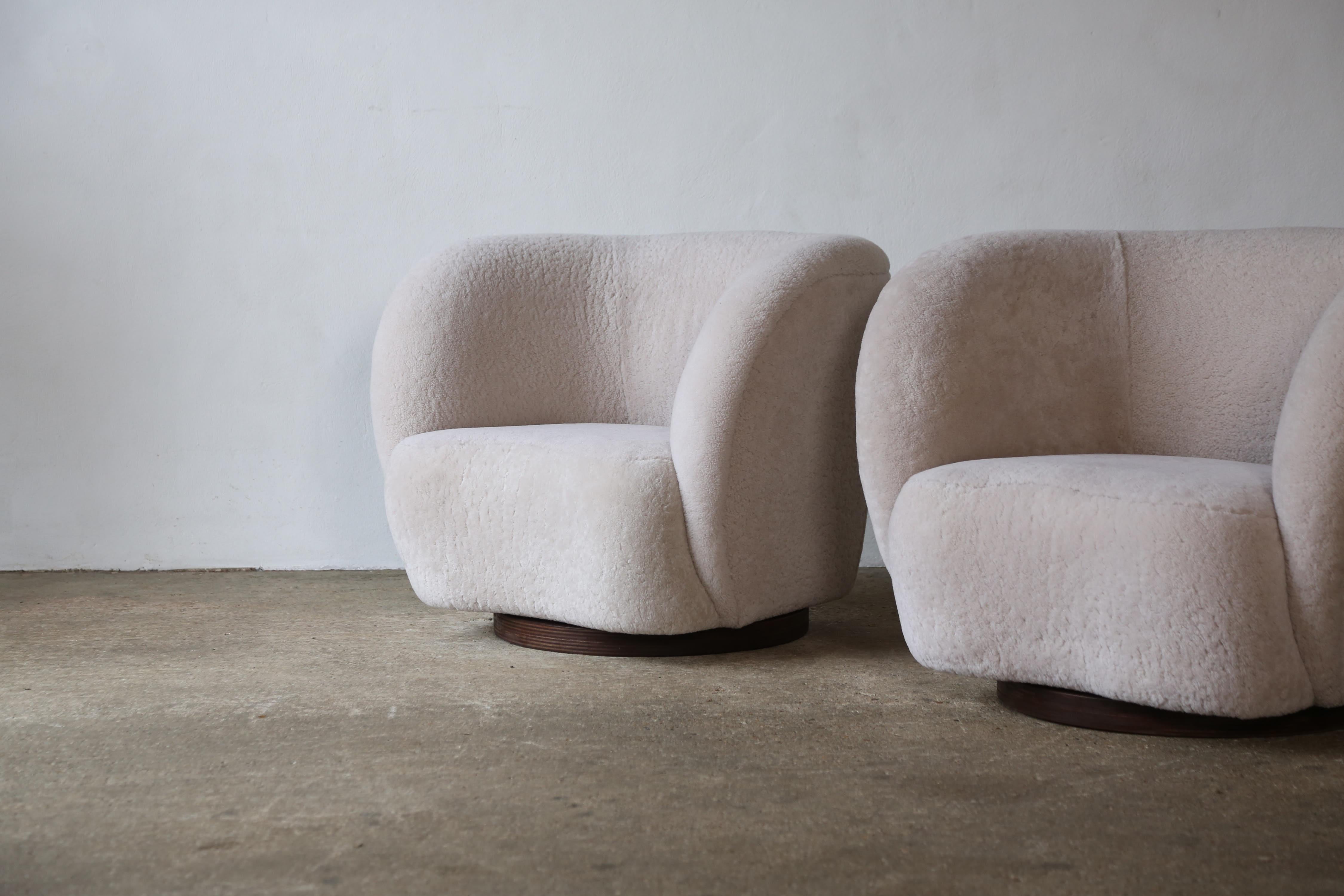 British A Pair of Swivel Lounge Chairs in Natural Sheepskin Upholstery For Sale