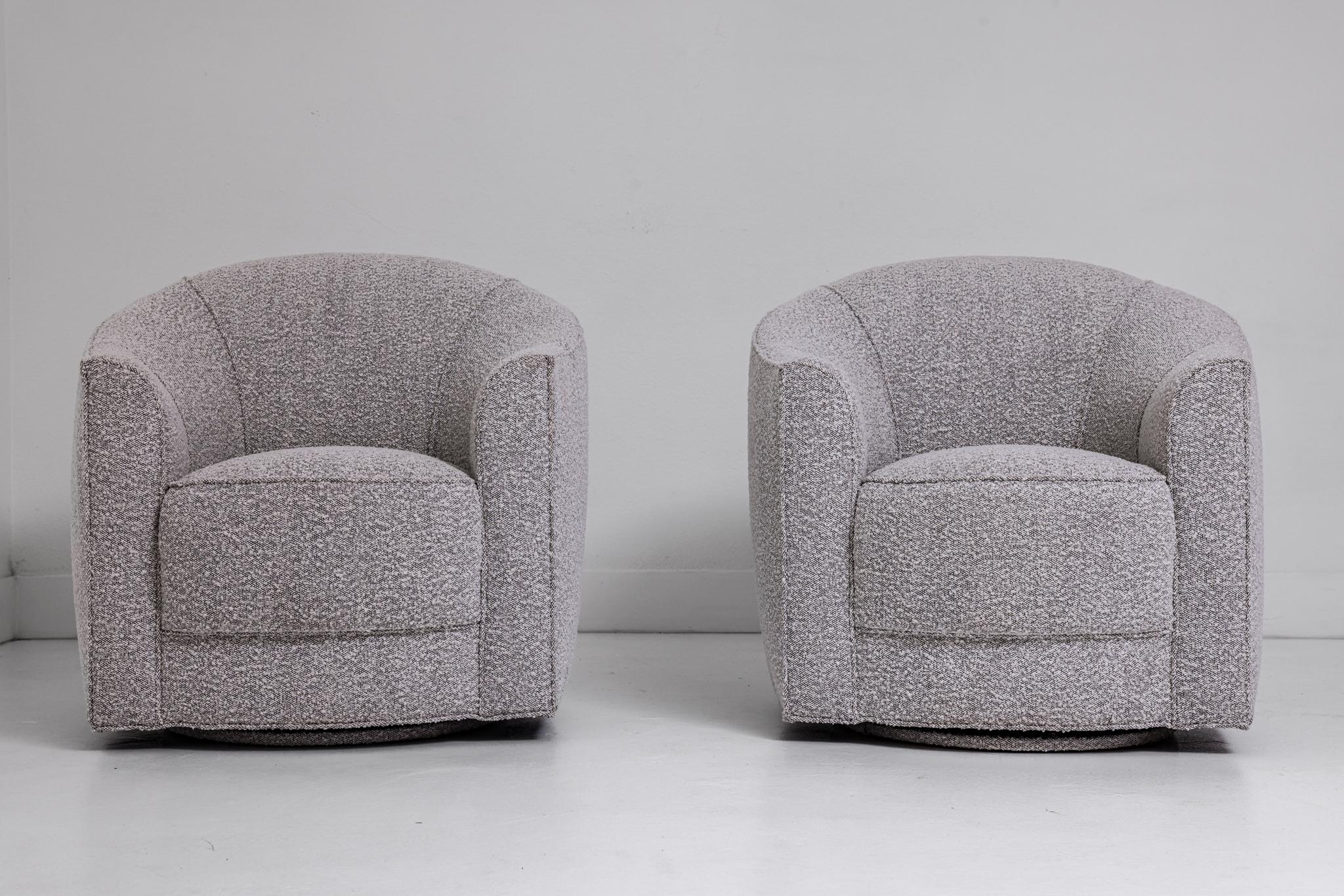 This pair of swiveling tub chairs were purchased from the estate of legendary insult comic Don Rickles. They have been newly upholstered in a unique bouclé, a creamy loop on a black ground. They have a welted scalloped back. These chairs are