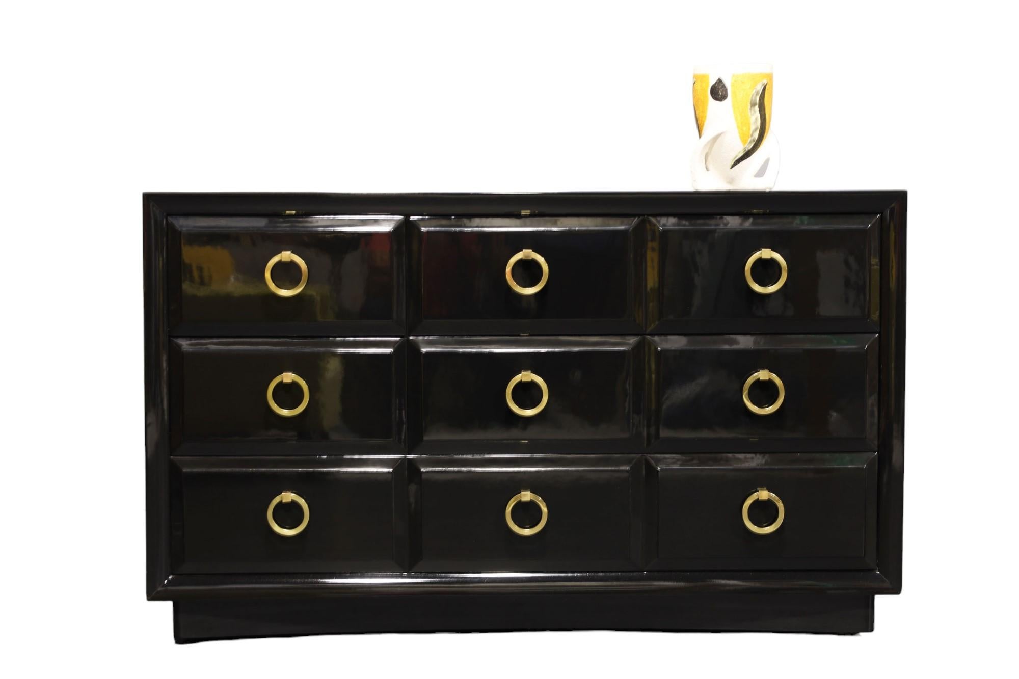 A pair of beautifully restored cabinet by Robsjohn-Gibbings for Widdicomb. This is a classic and quite substantial. We have expertly black lacquered. Pulls are solid brass and have been polished and sealed.  