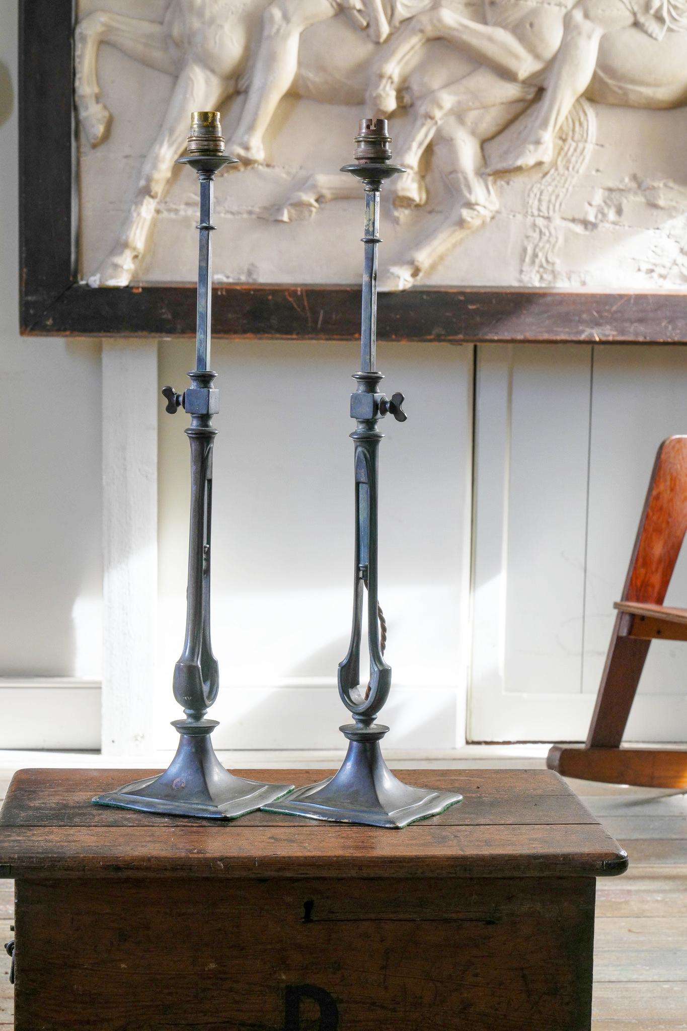 A pair of patinated brass extending table lights by F.C. Osler of London.