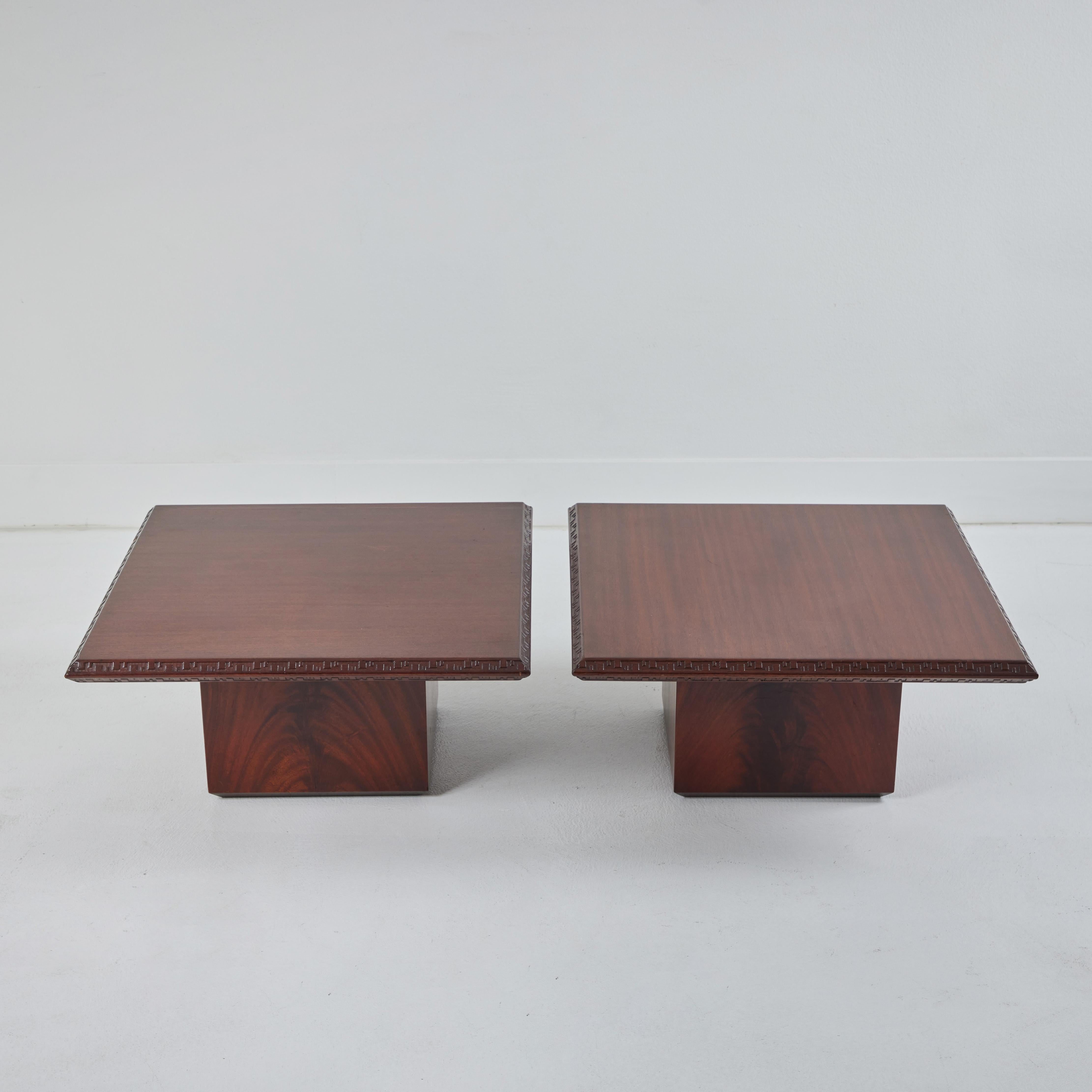 Here are a pair of low mahogany cocktail tables designed by Frank Loyd Wright as part of his Taliesin collection. Designed in 1955 for Heritage Henredon, these tables are beautifully constructed. Made from mahogany, these sleek low coffee tables are