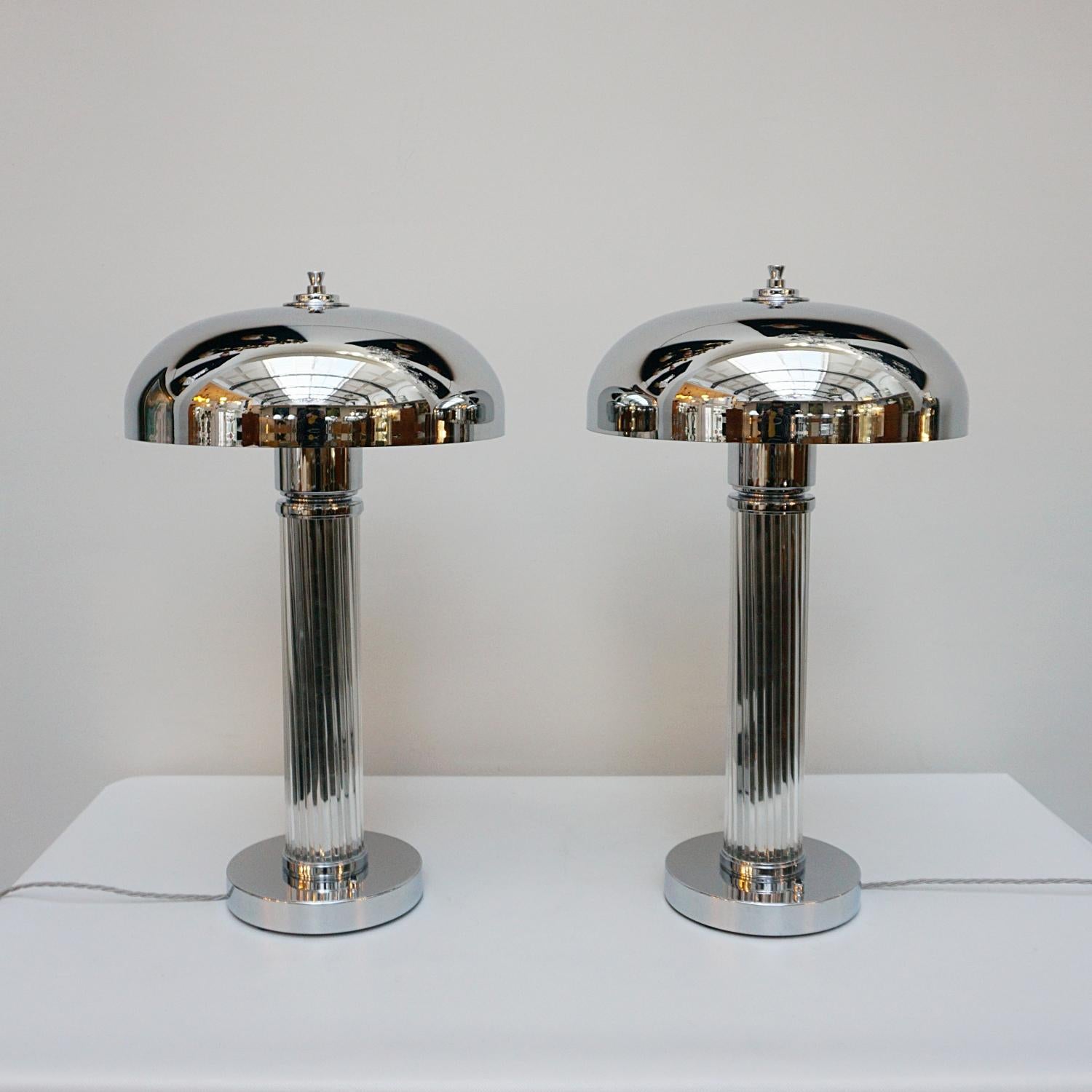 A pair of tall Art Deco style dome lamps. Glass rod stem over a chromed metal circular base and a chromed metal shade. Chrome finial to top. 

Dimensions: H 65cm W 20cm

Origin: English

Item Number: J302

All of our lighting is fully refurbished,