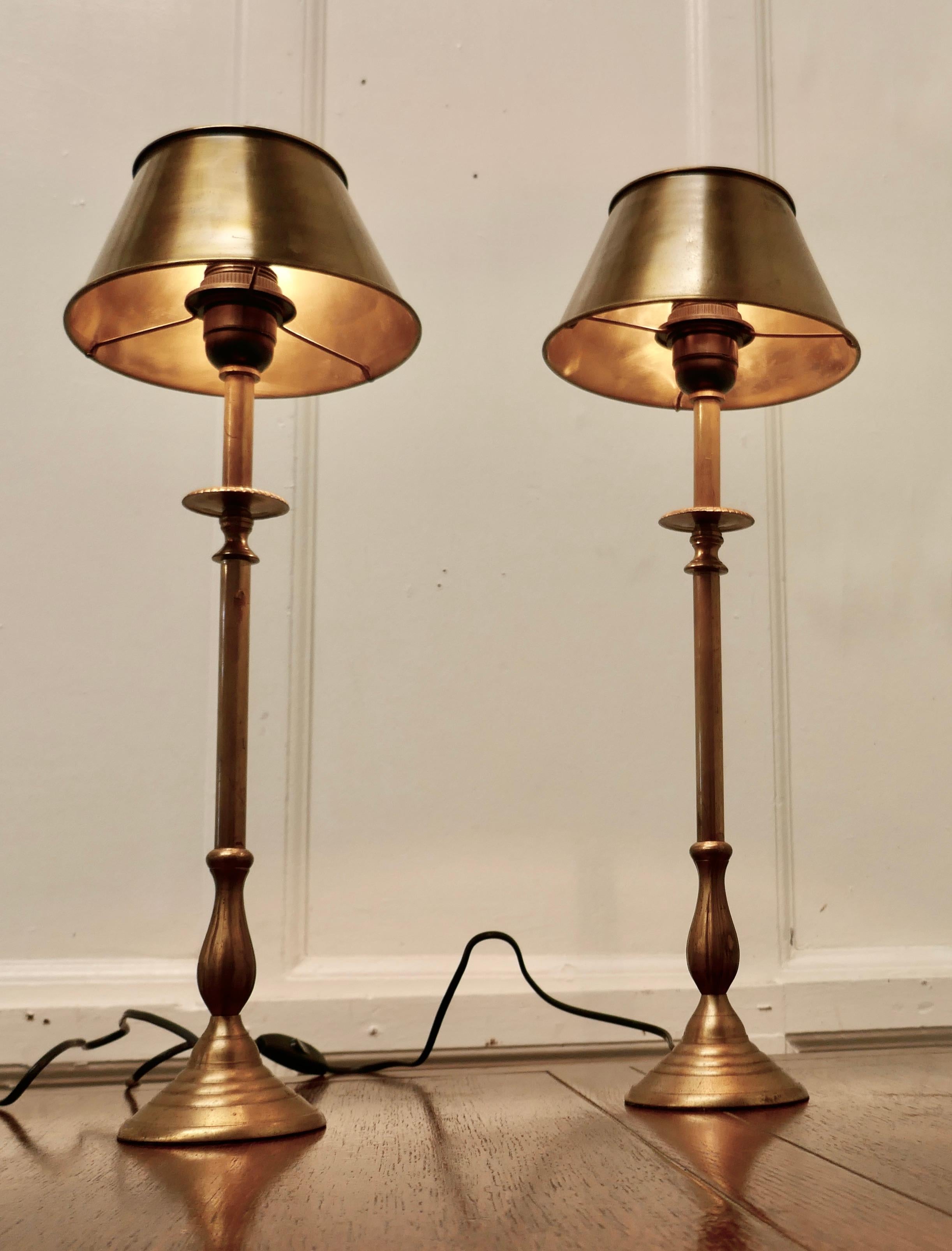 A Pair of Tall French Brass Column Table Lamps with Brass Shades

These are a very attractive pair of bedside lamps they each have a single column and a brass lampshade
The lamps are in good condition, working and with a good natural patina. The