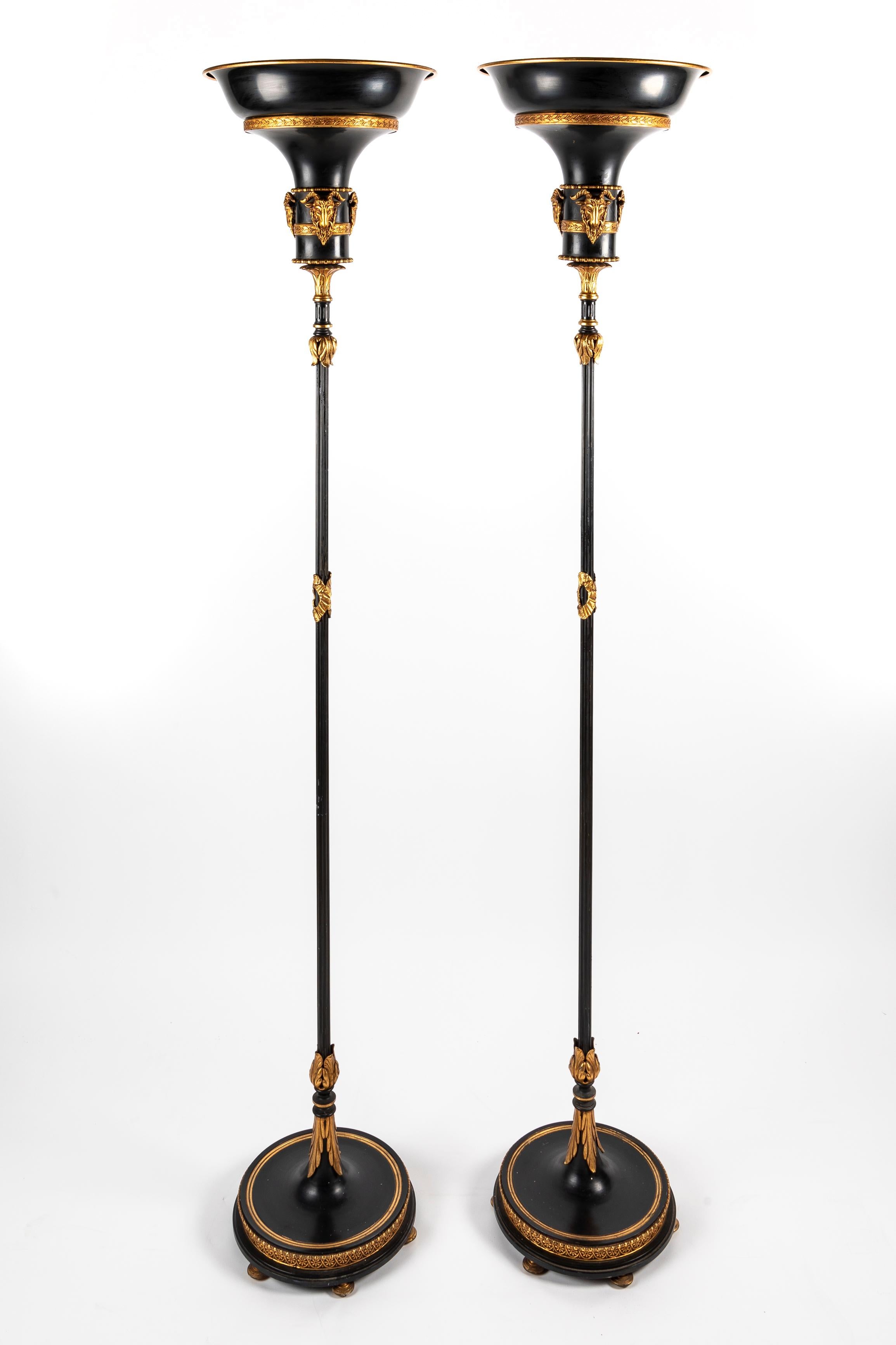 A Pair of unique tall Hollywood Regency French Patinated bronze and gilt bronze circular form floor lamps of great detail embellished with neoclassical motifs and further adorned with gilt bronze figural masks. 