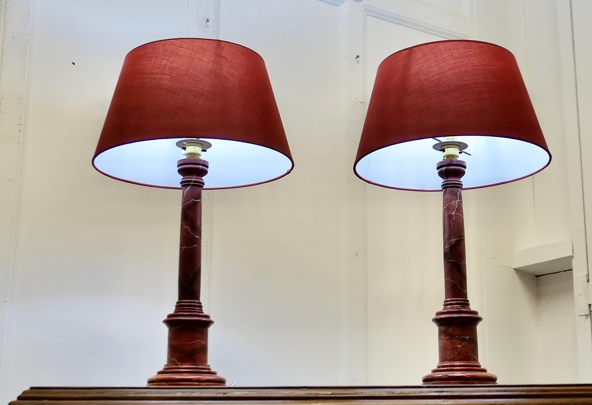 A Pair of Tall Simulated Marble Bedside Lamps with Shades

These are a very attractive pair of lamps they have a single corinthian style carved column set on a round stepped base, they have matching fabric shades
The lamps are in good condition,