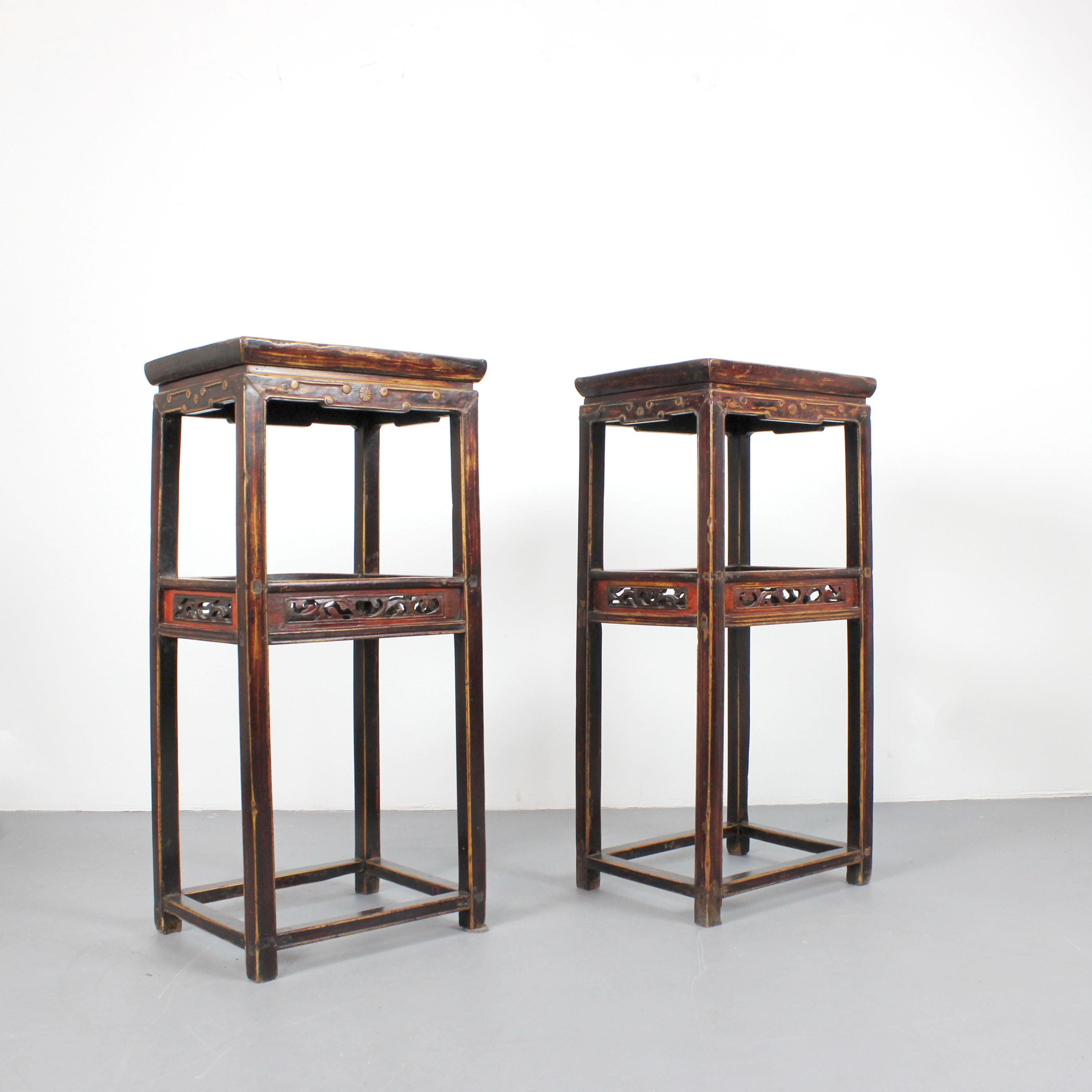 A pair of tall tables, stools, or pedestals crafted from carved and polychromed wood. Qing Dynasty, China.