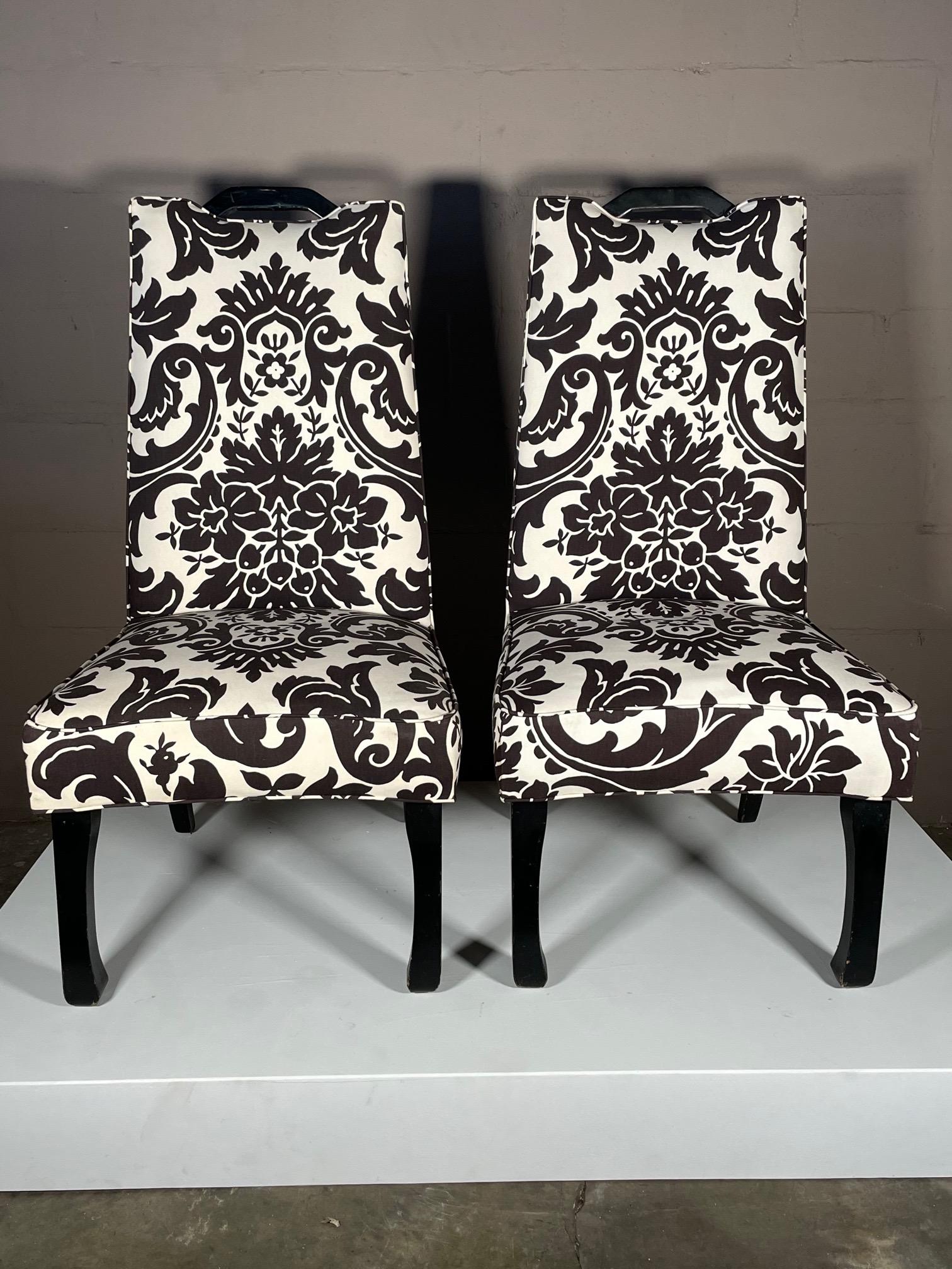 A pair of stylish, asian style, tall back chairs with black laquered handles. Upholstered in cotton, black/white abstract print.