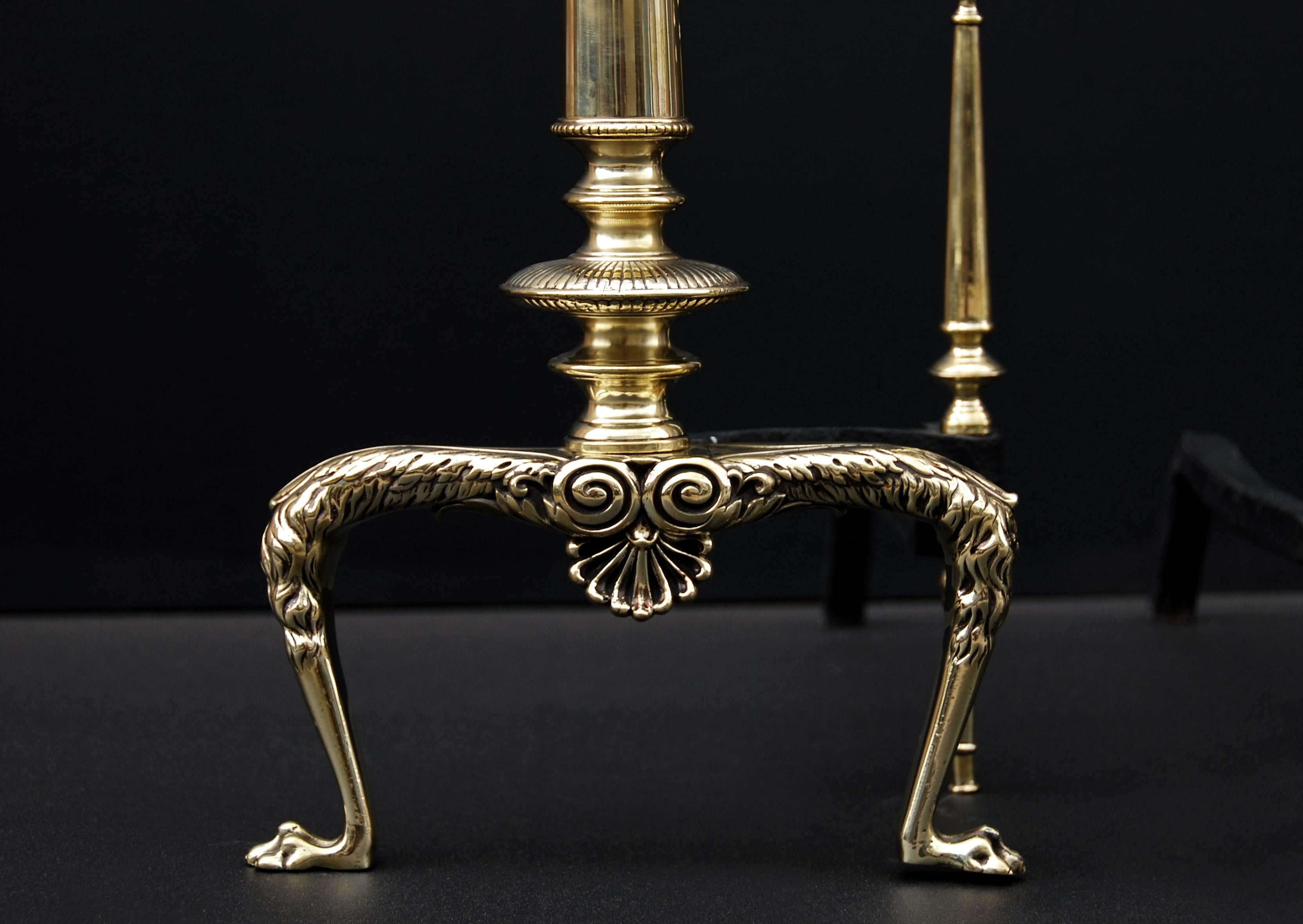 A pair of elegant 19th century English brass firedogs. The scrolled feet surmounted by tapering cylindrical columns and finials to top.

Height:	755 mm      	29 ¾