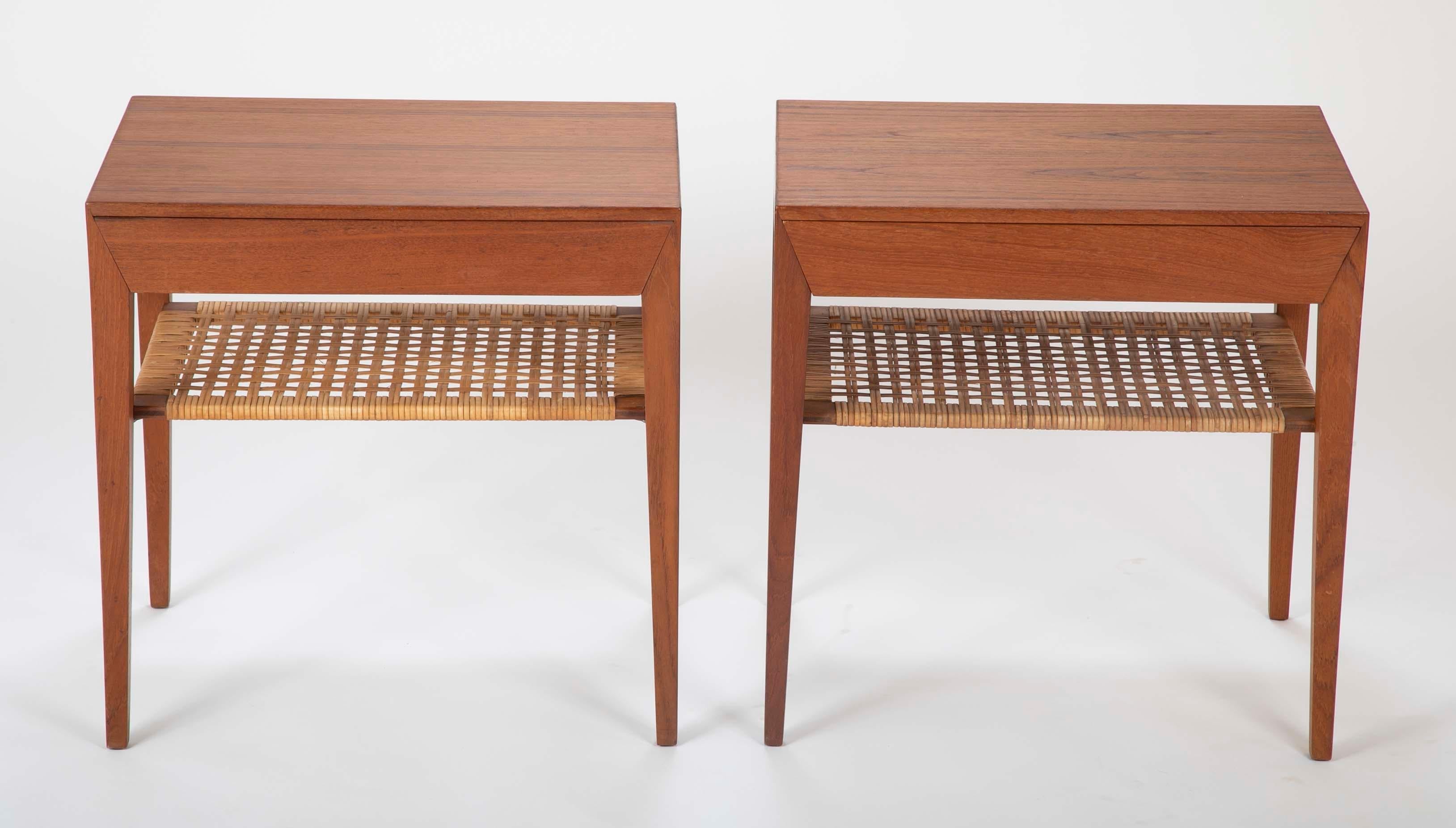 A pair of teak side tables designed by Severin Hansen Jr. with rush caned shelf and a single drawer. Produced by Haslev Møbelsnedkeri. One with Haslev & Danish control labels, the other without labels.