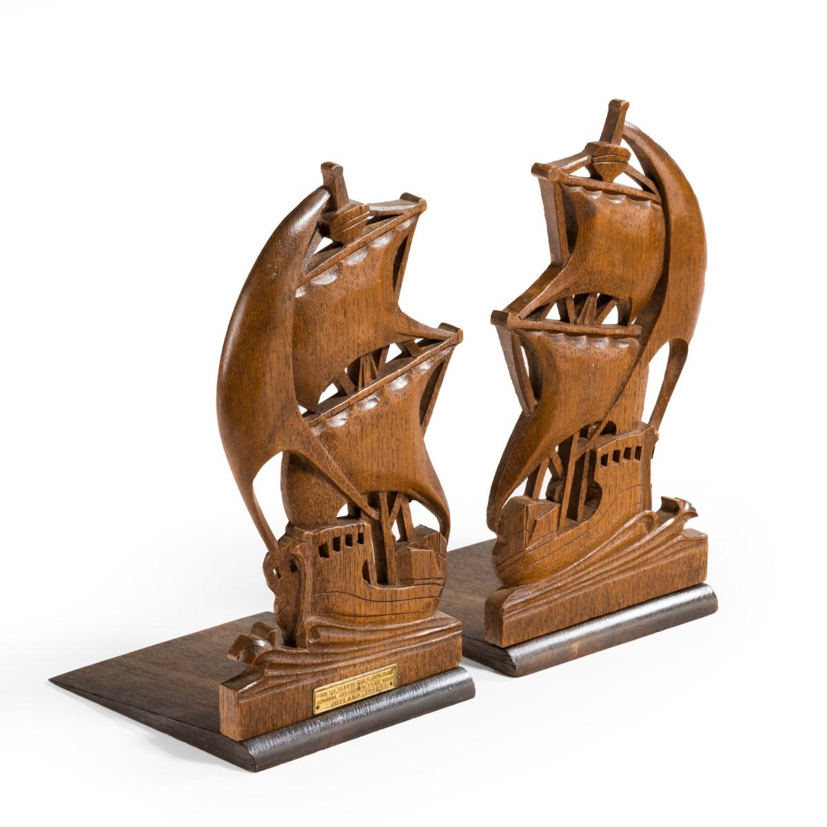 A pair of teak book ends from HMS iron duke, each in the form of a battleship under sail, one with an applied plaque stating

‘From the Teak of HMS Iron Duke, Admiral Jellicoe’s Flag Ship. Jutland 1916.’