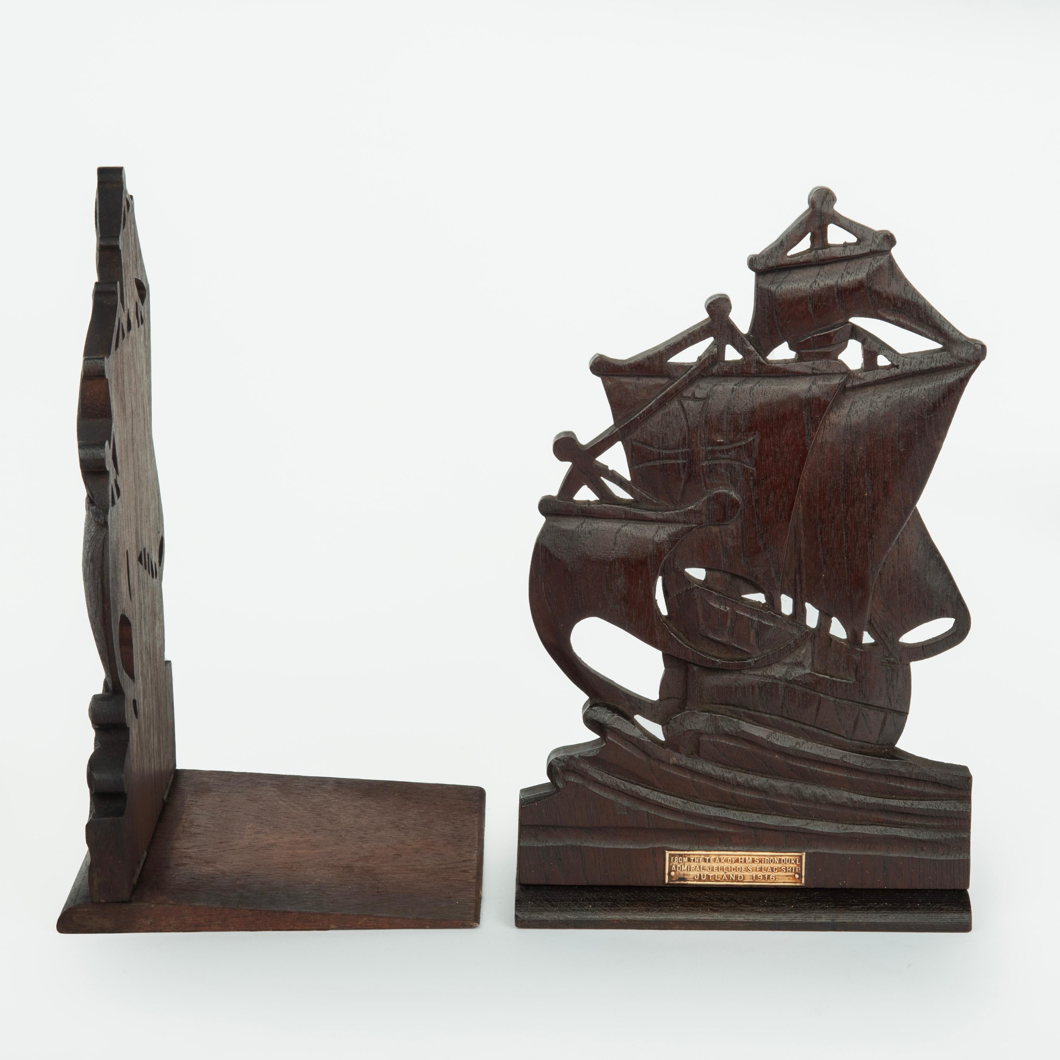 A pair of teak bookends from the Iron Duke, Battle of Jutland, 1916, each in the form of a battleship under sail with a copper plaque reading ‘From the Teak of HMS Iron Duke, Admiral Jellicoe’s Flagship, Jutland 1916’.
