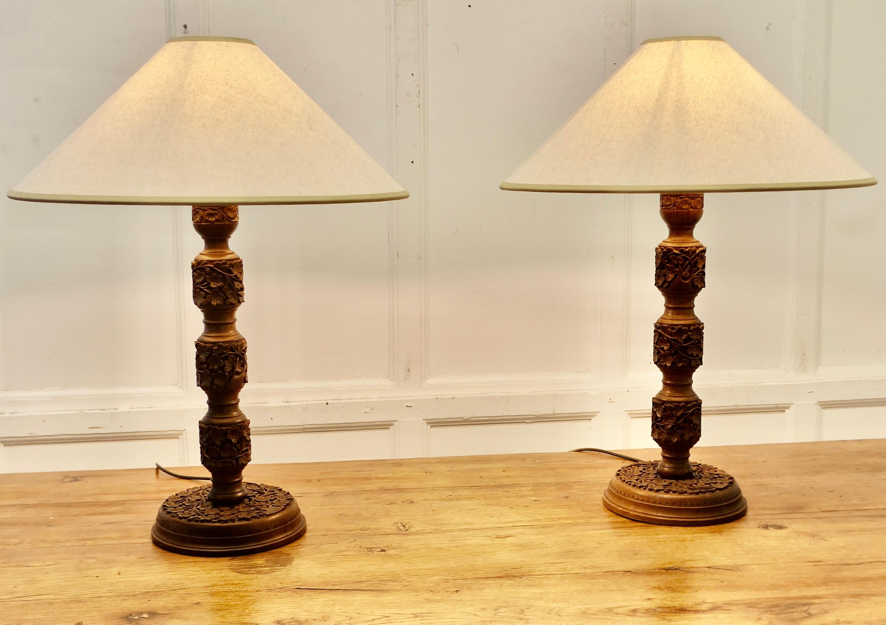 A Pair of Teak Carved Tree of Life Table Lamps


A superb pair of large lamps, with expert carving, the Tree of Life theme is on the base and carried through the length of these tall lamps
The wiring is new and the shades have been matched with good