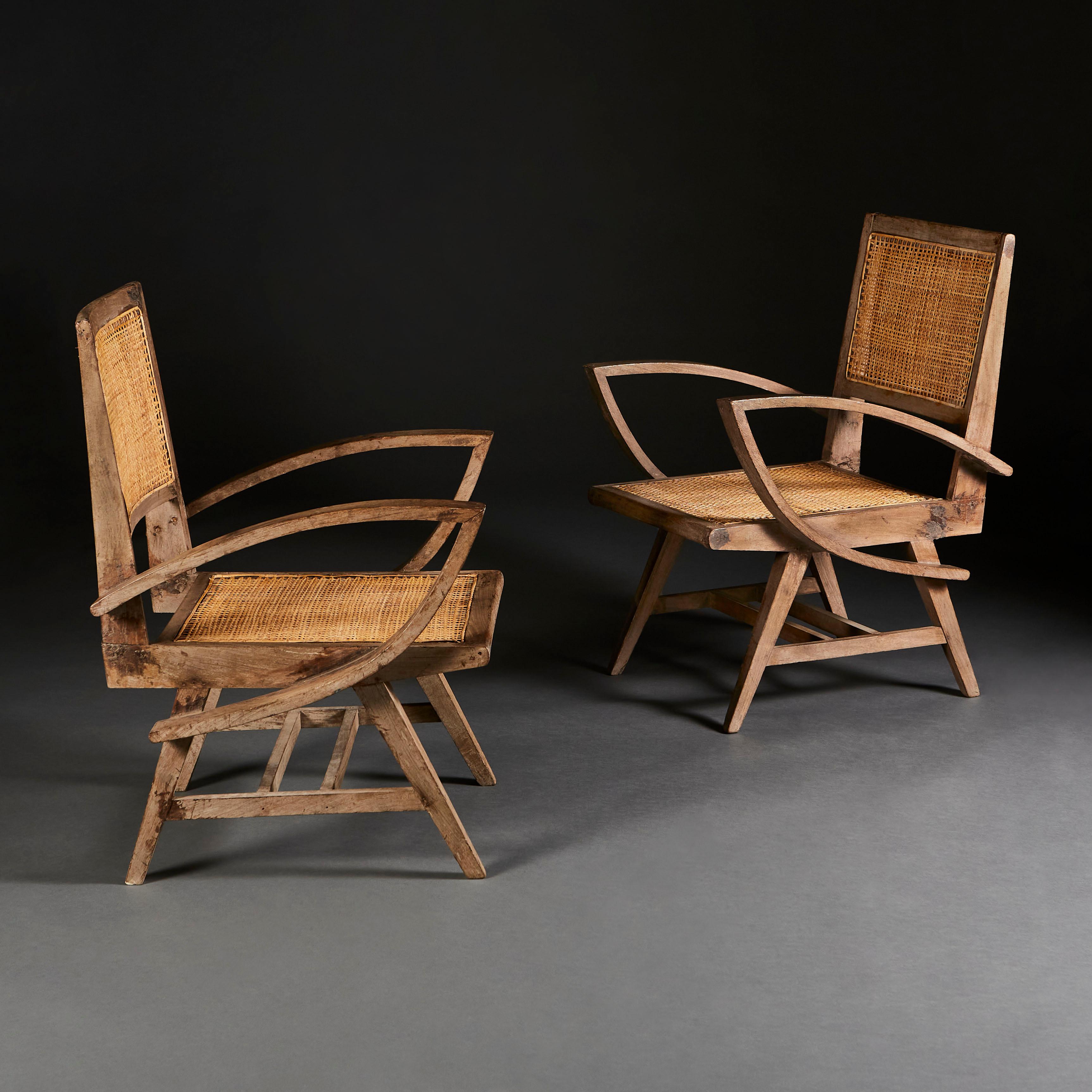 A pair of teak Chandigarh armchairs with caned backs and seats, with lotus leaf form arms, after Pierre Jeanneret.

When Swiss architect Pierre Jeanneret devised a teak-and-cane chair in the 1950s, his reasoning was simple: The people needed