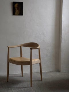 A pair of 'The Chair' by Hans J Wegner (1949) in soap treated oak and leather.