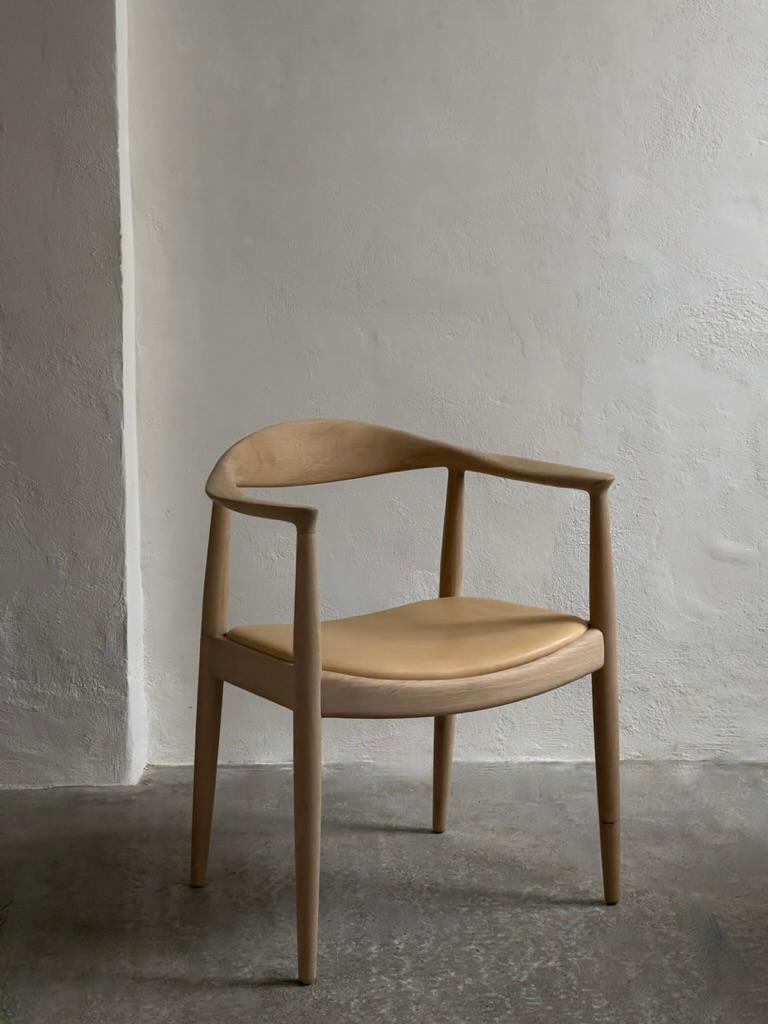 Scandinavian Modern A pair of 'The Chair' by Hans J Wegner (1949) in soap treated oak and leather.