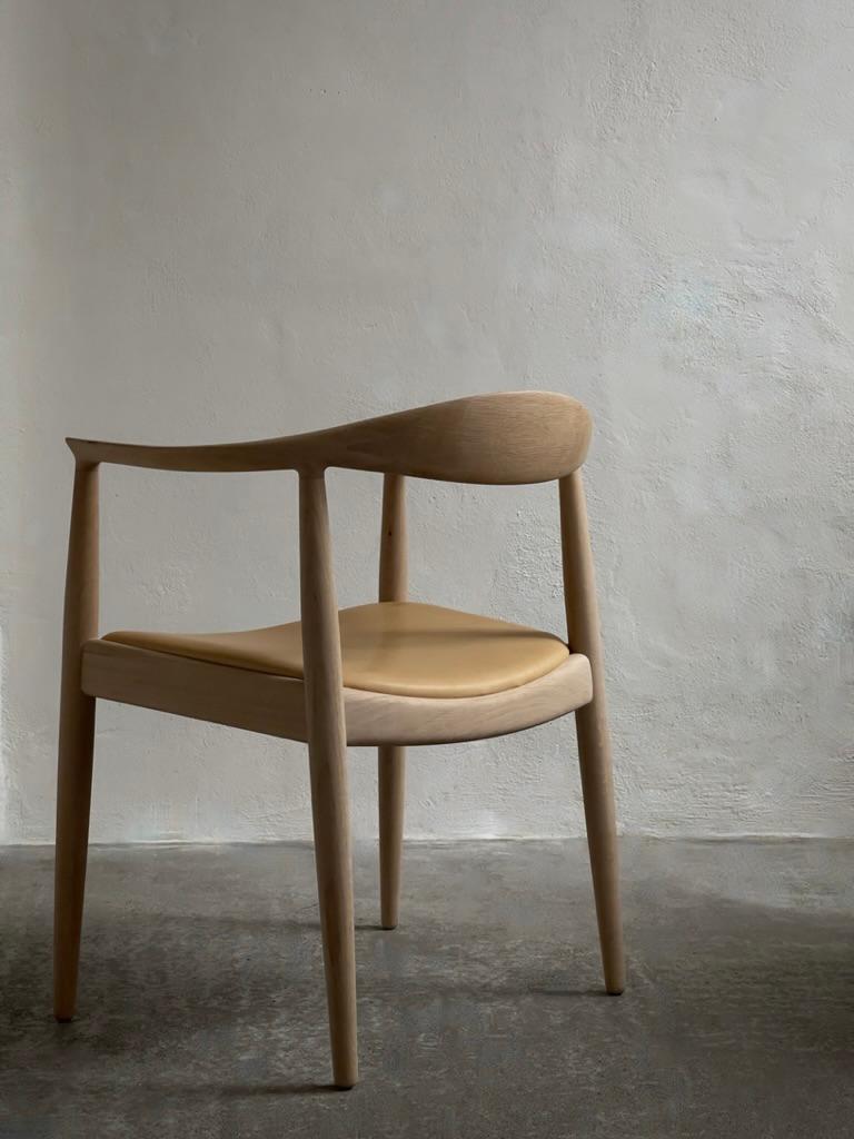 Leather A pair of 'The Chair' by Hans J Wegner (1949) in soap treated oak and leather.