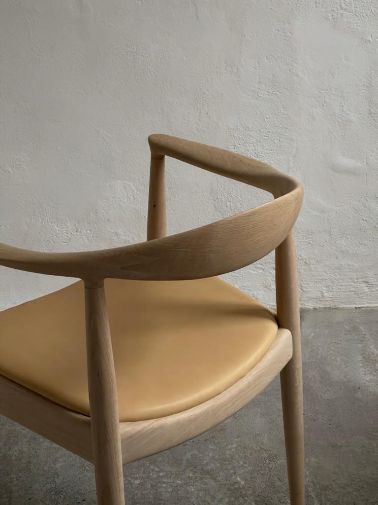 A pair of 'The Chair' by Hans J Wegner (1949) in soap treated oak and leather. 1