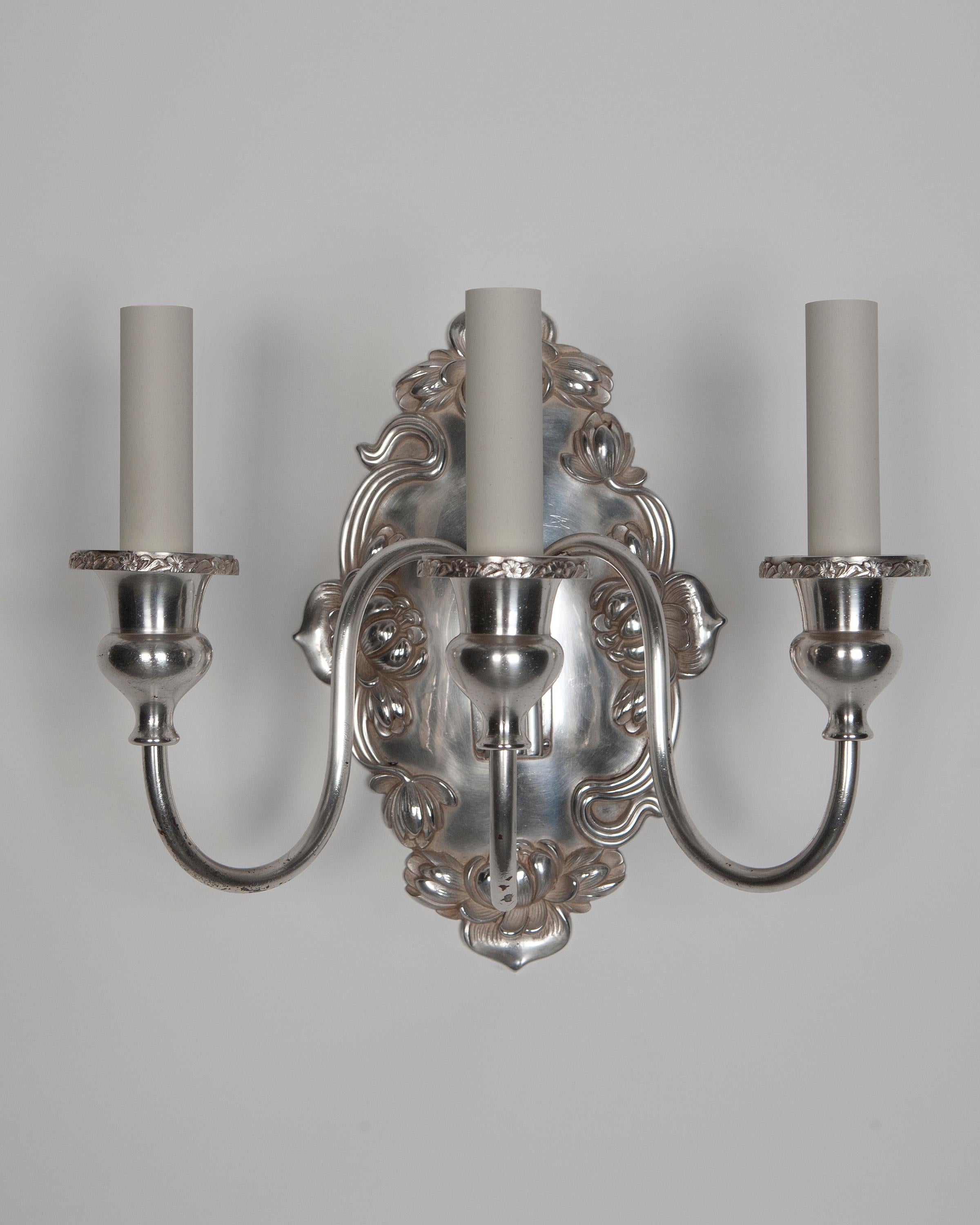 AIS2760

A pair of three light sconces with foliate details in their original silverplate finish. Signed by the New York maker Sterling Bronze Co.

Dimensions:
Overall: 12