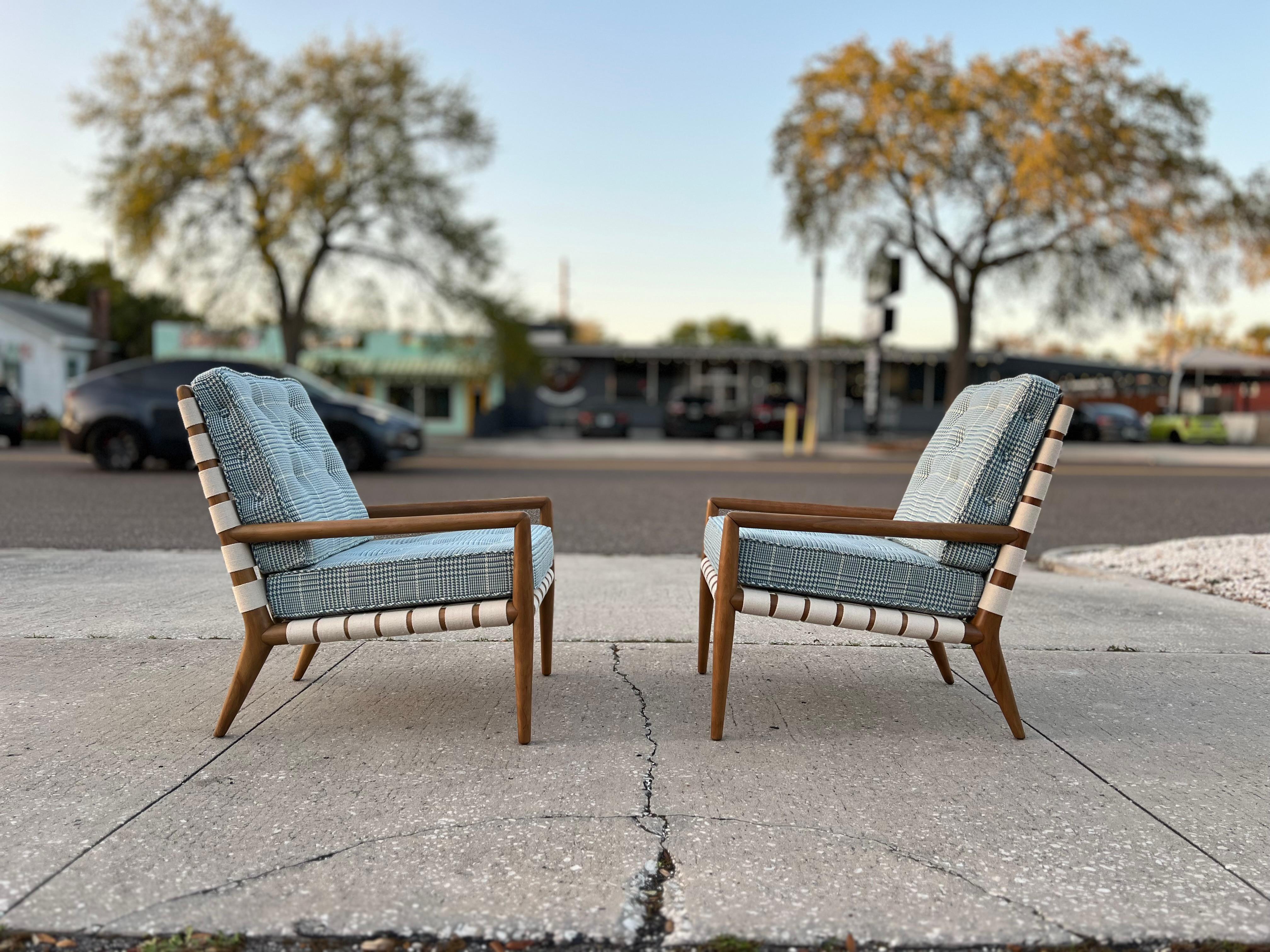 A pair of fabulous, original T.H.Robsjohn-Gibbings arm chairs with strapping. Model # 1720, as referenced in the vintage Widdicomb catalog, these chairs are original and vintage ca' 1950's. Completely restored with new finish, new strapping and new