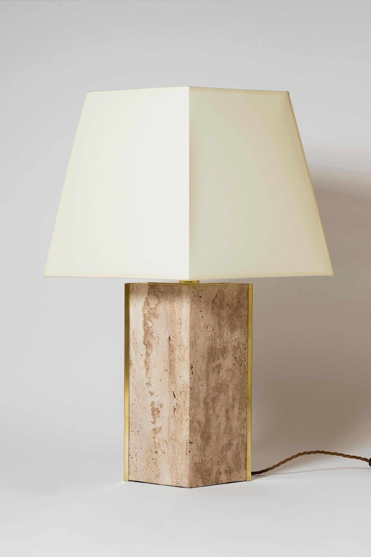 A pair of 'Marine' table lamps, by Dorian Caffot de Fawes.
Limited Edition of 12 singles lamps. These numbered 1/ 12 and 2/12.
Solid Italian quarried travertine, with brass mounts and bespoke diamond shaped shades (made in the UK)
Measures: With the