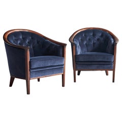 A pair of tub chairs by Bertil Fridhagen in walnut and velvet circa 1960