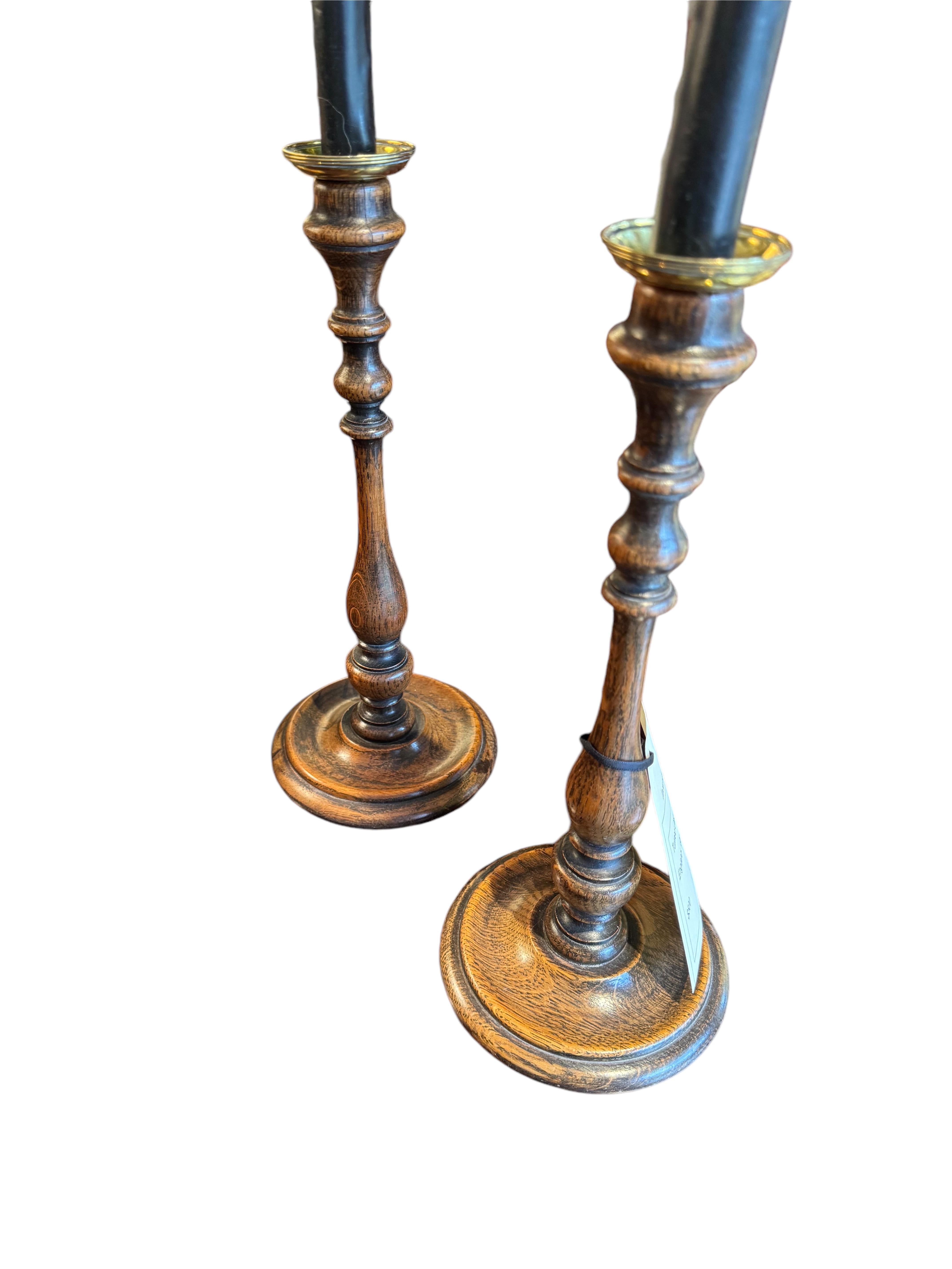 A Pair of Turned Candlesticks
With Brass Bobashes. 