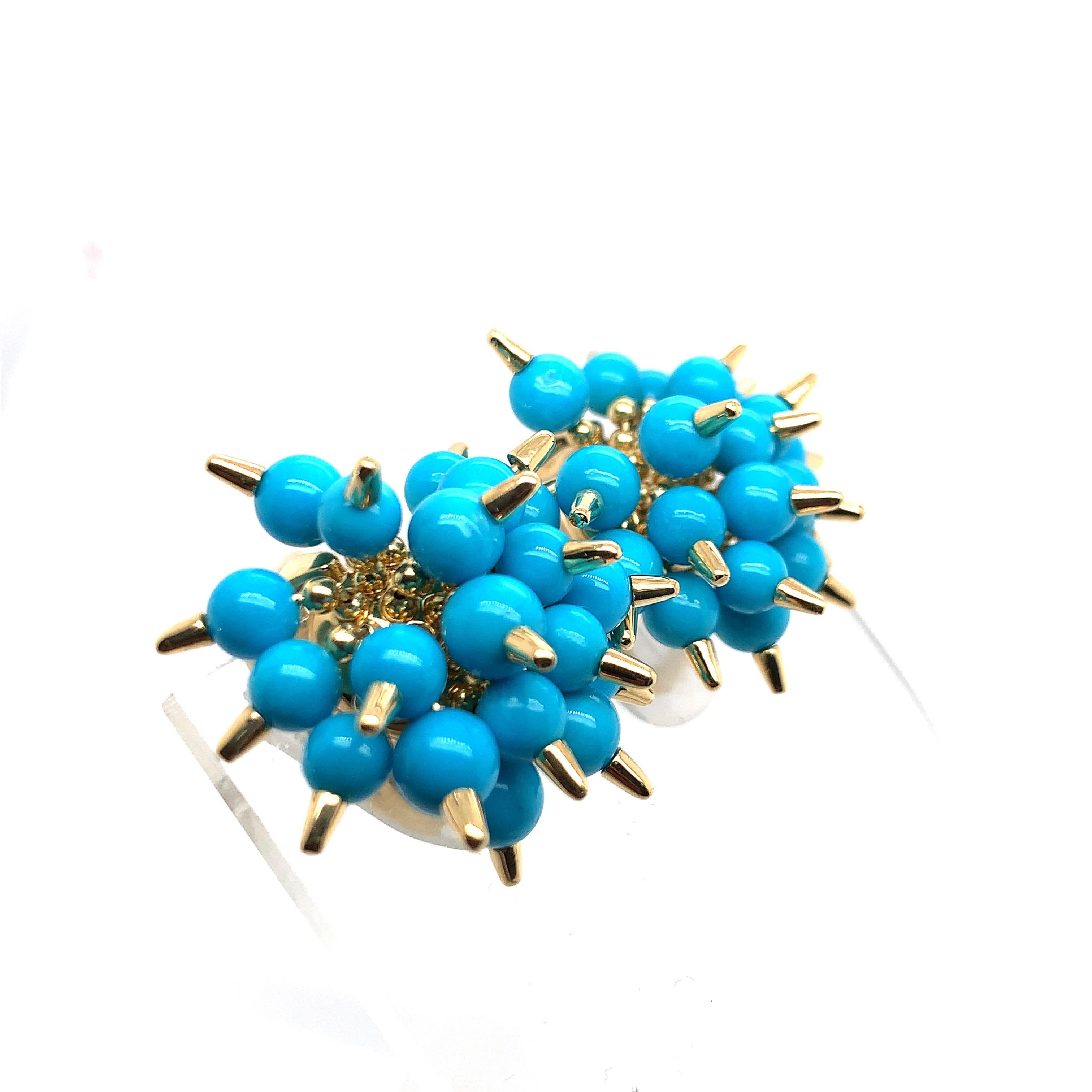 Each large circular domed form fashioned with a spiky pom-pom motif composed of articulated turquoise beads with elongated pointed centres, in 18k gold

Weight: 24.9 grams
Measuring approximately 28 mm wide
Marks: Aletto Bros, G12, 750, USA
With